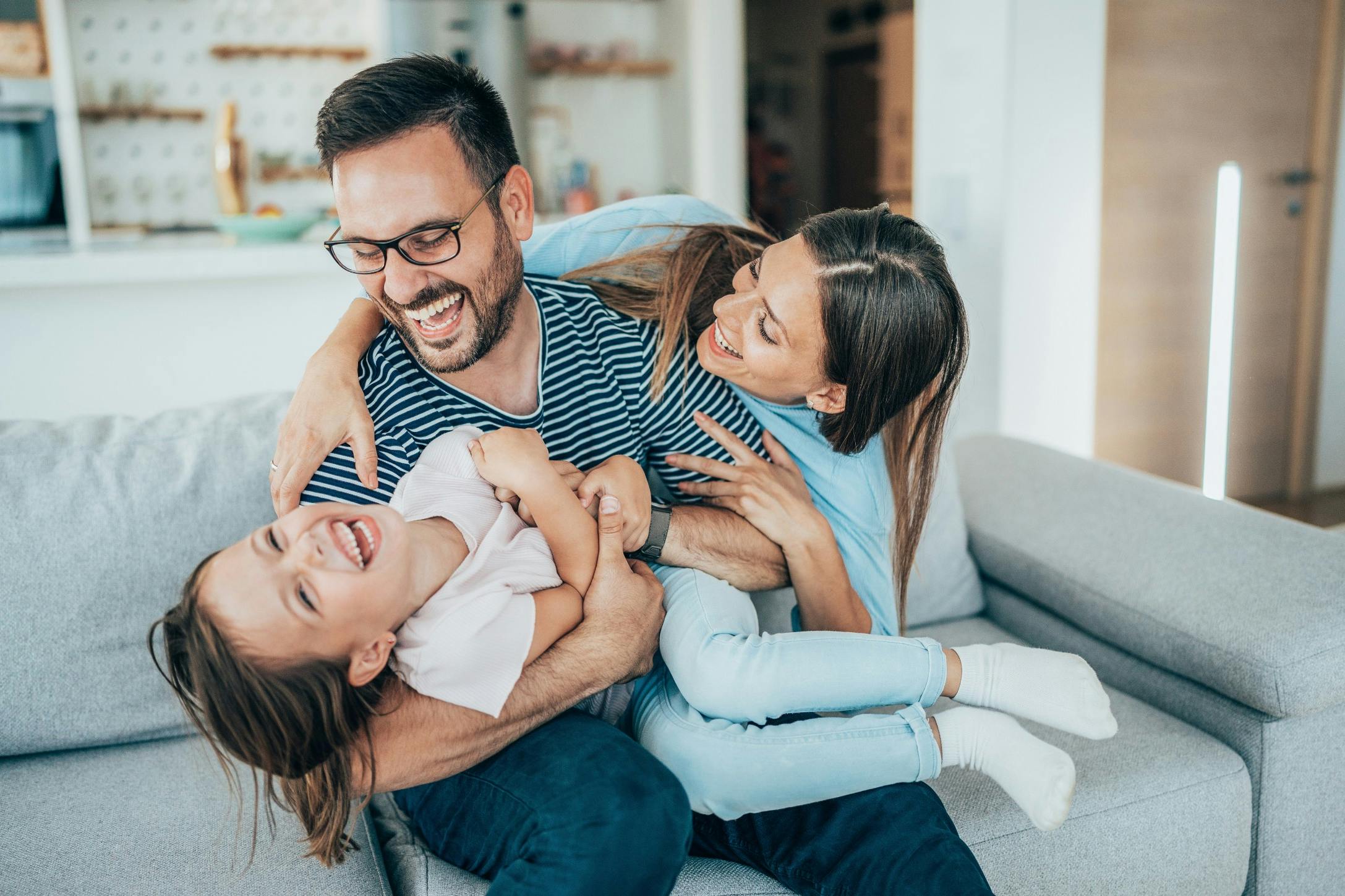 happy healthy dad with wife and daughter