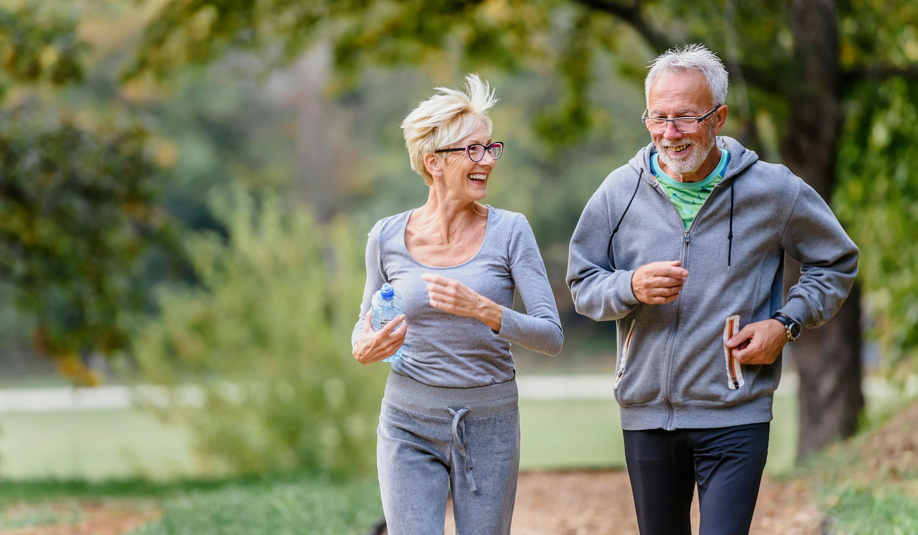 cheerful active senior couple running