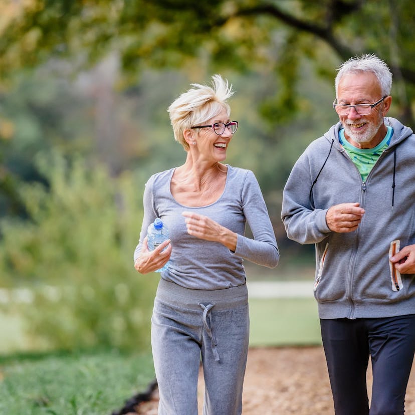 cheerful active senior couple running