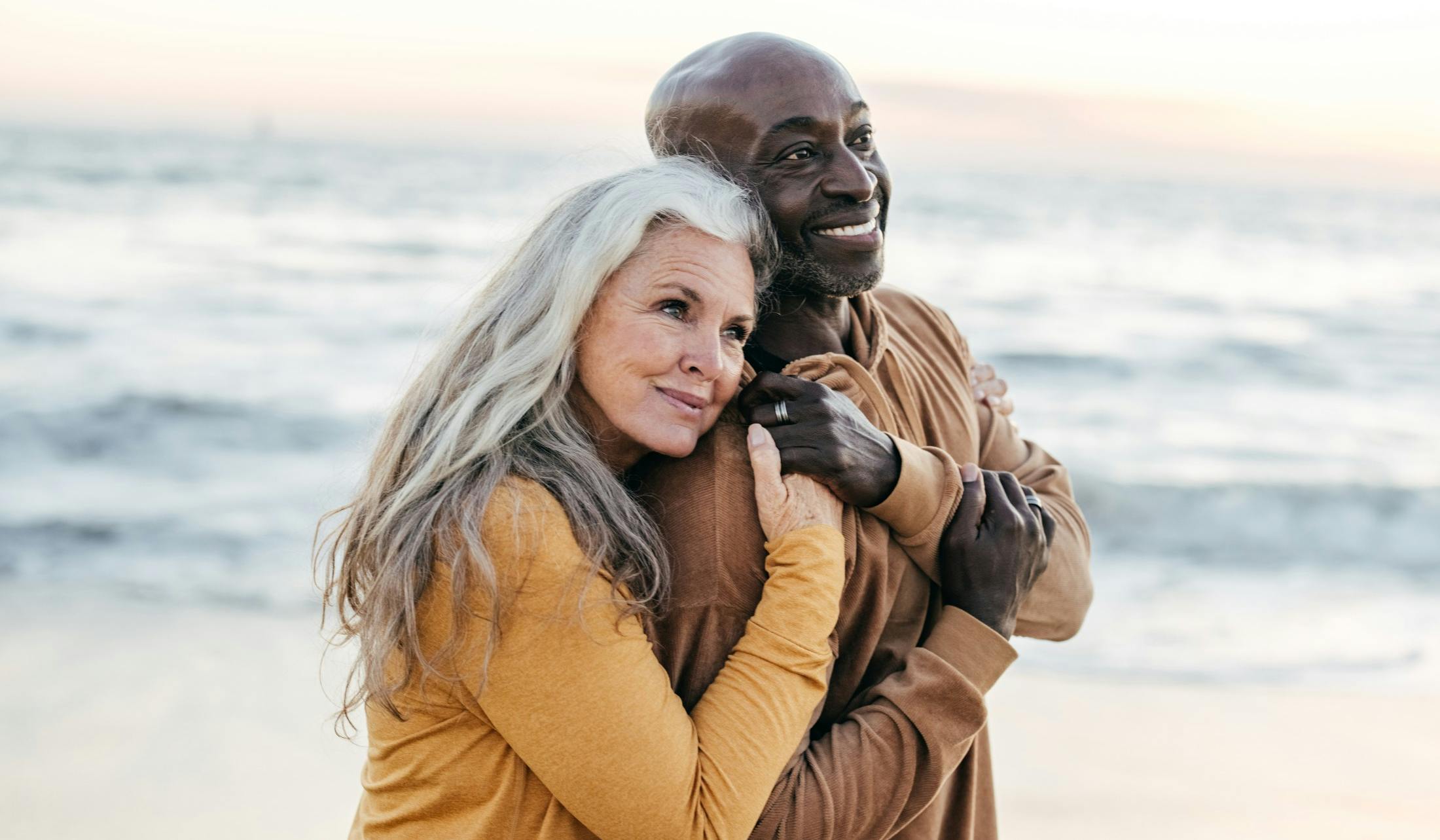 happy middle age couple at the beach