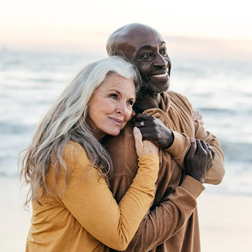 happy middle age couple at the beach