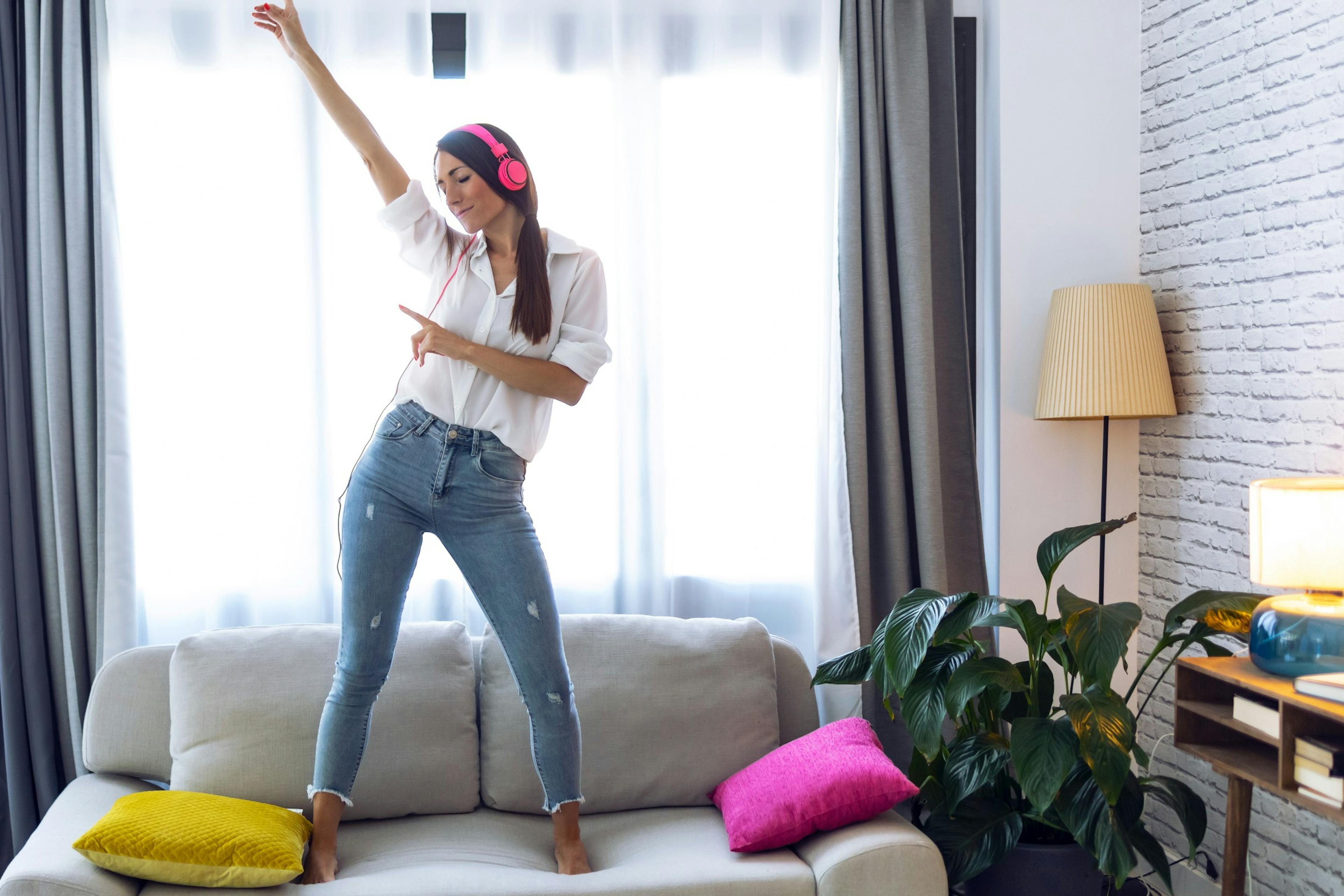 woman dancing on the couch