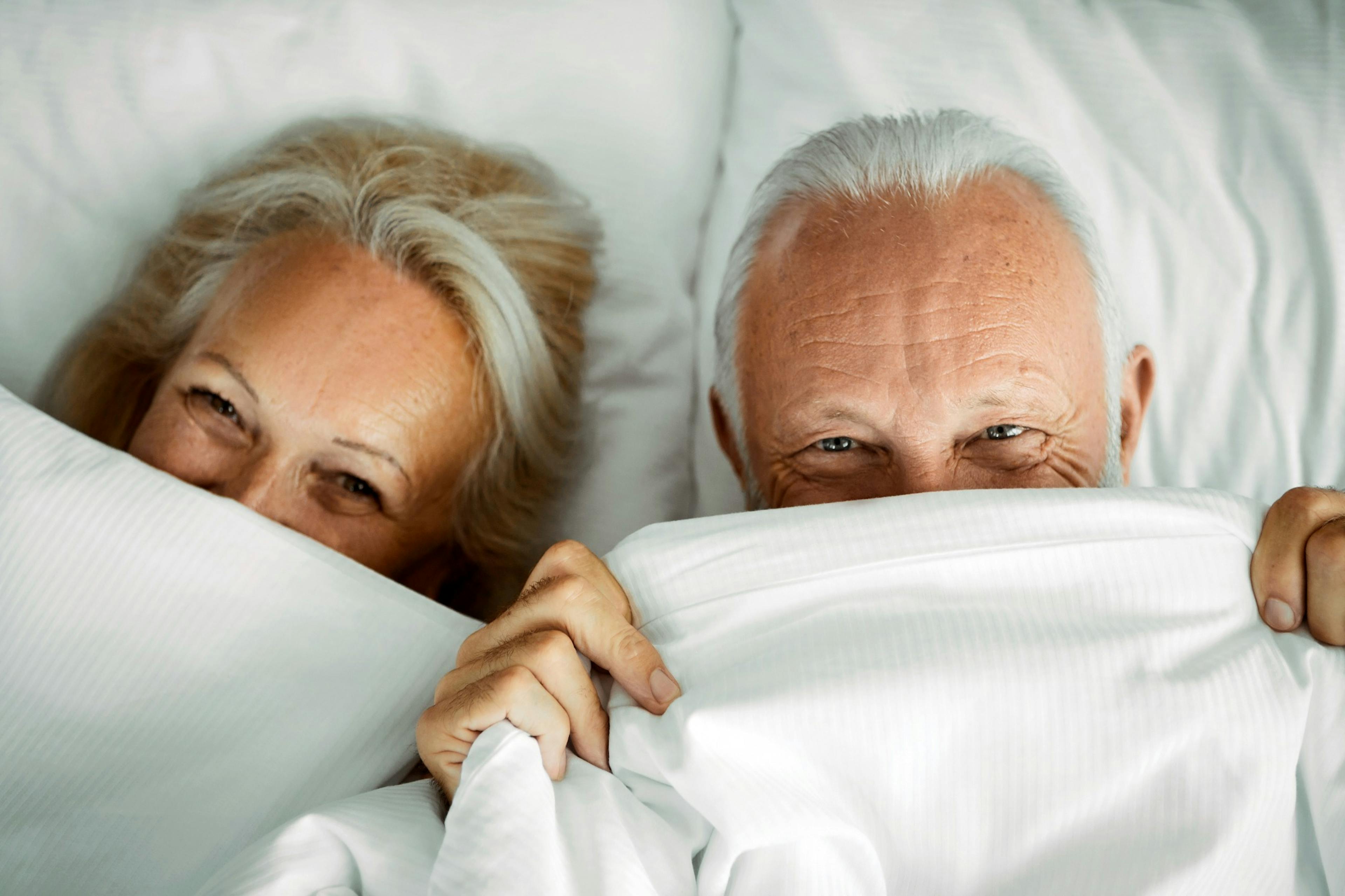 happy senior couple in bed