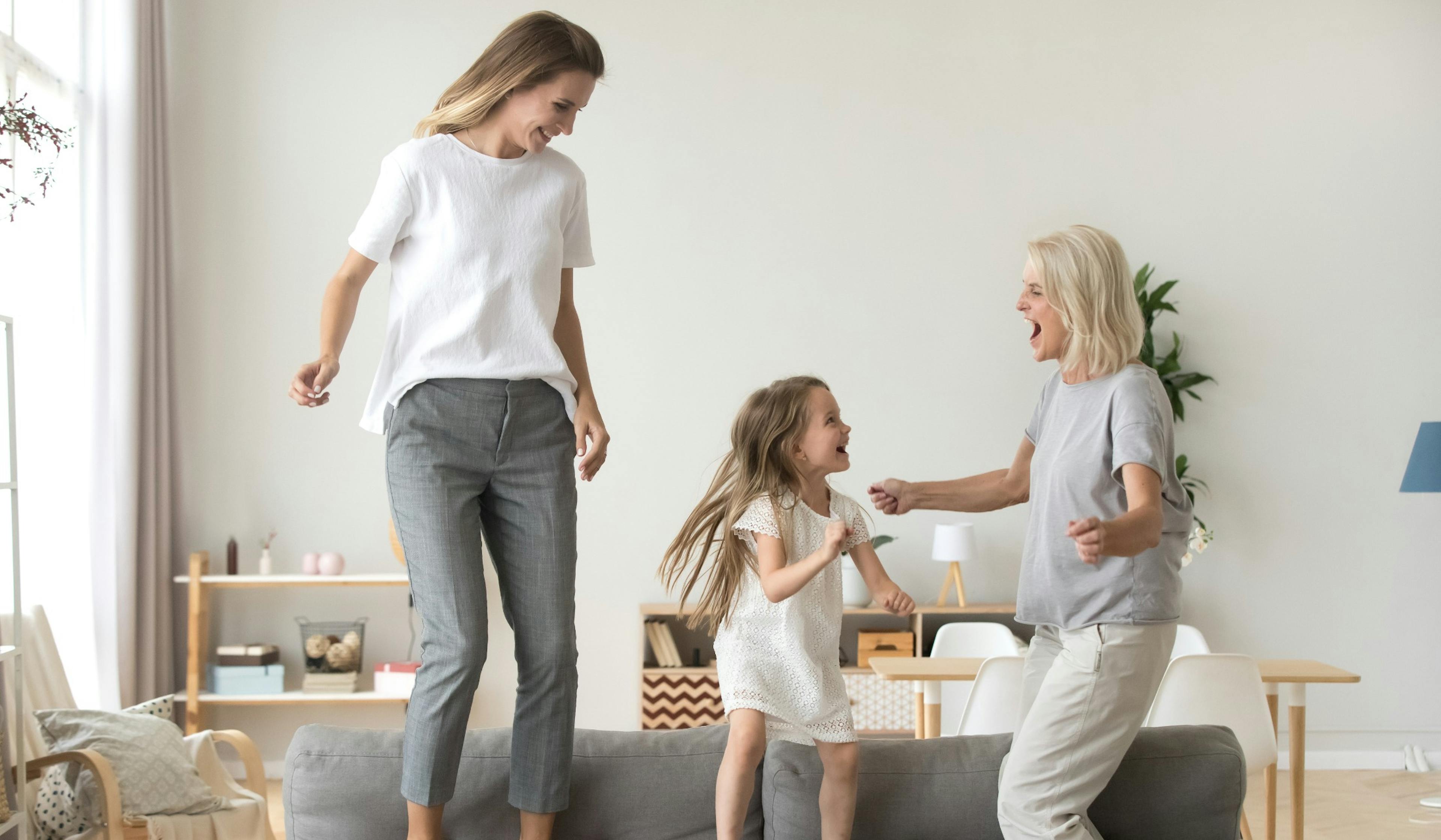 three generations happily dancing