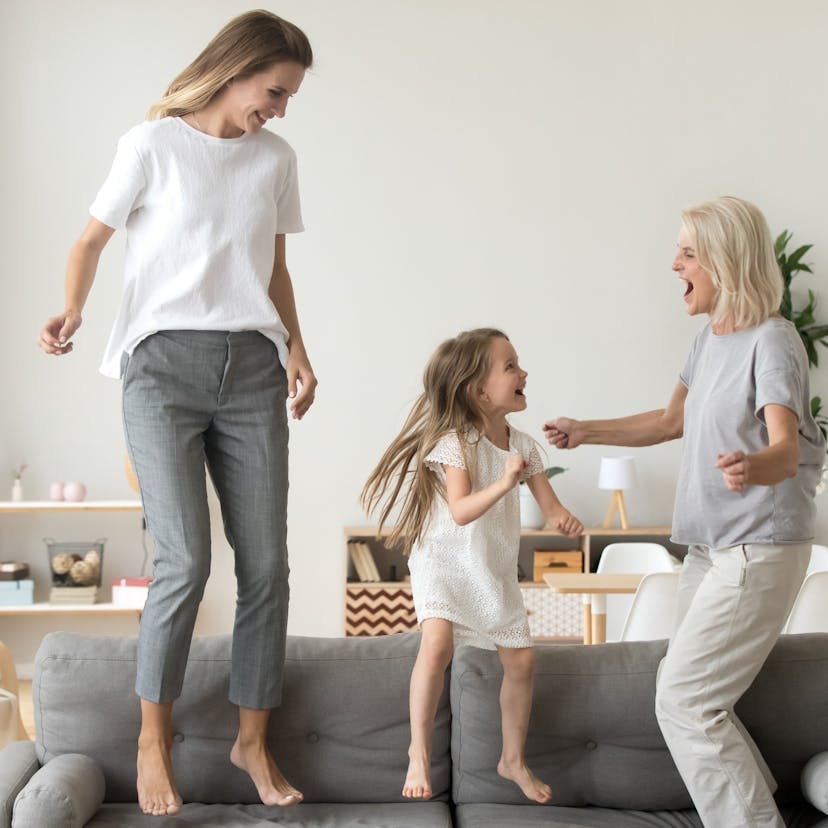 three generations happily dancing