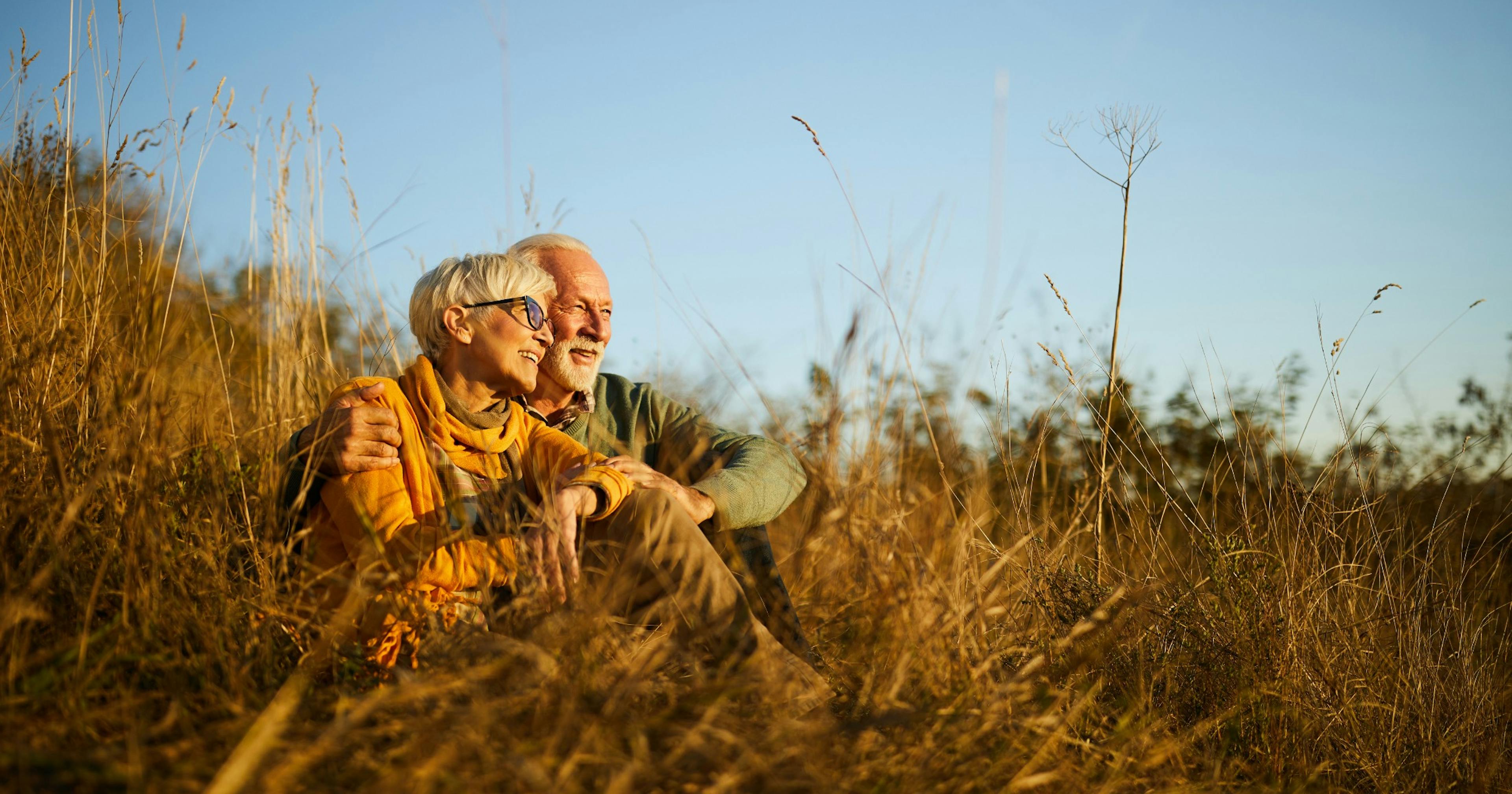 happy senior couple in the grass