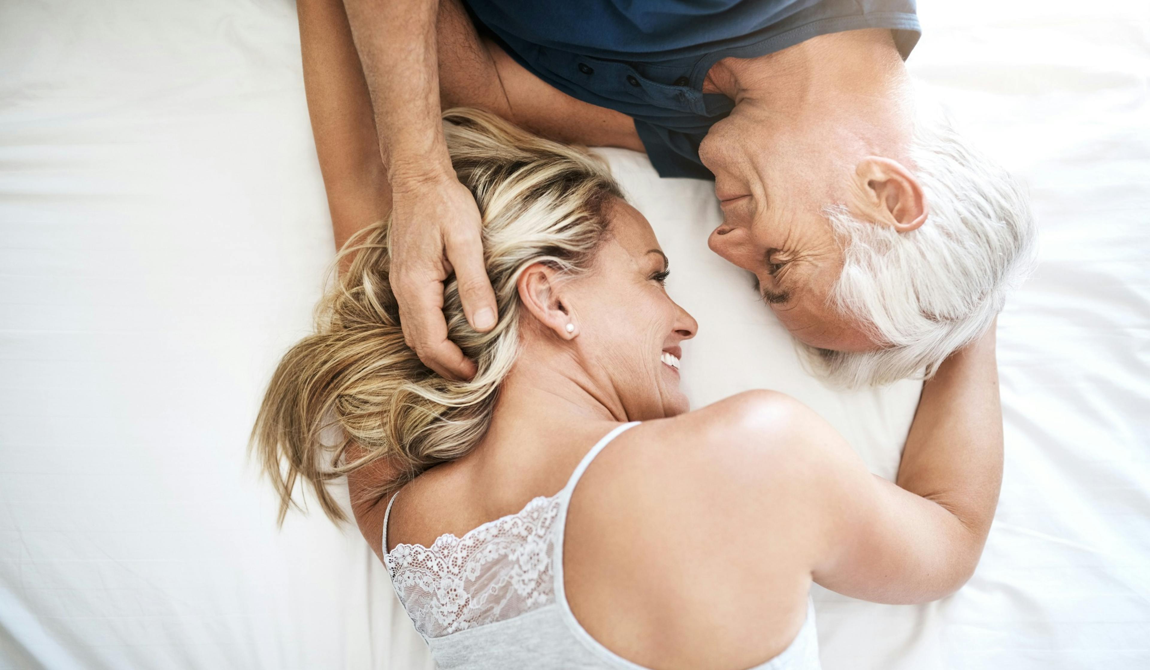 happy coupe laying on bed.