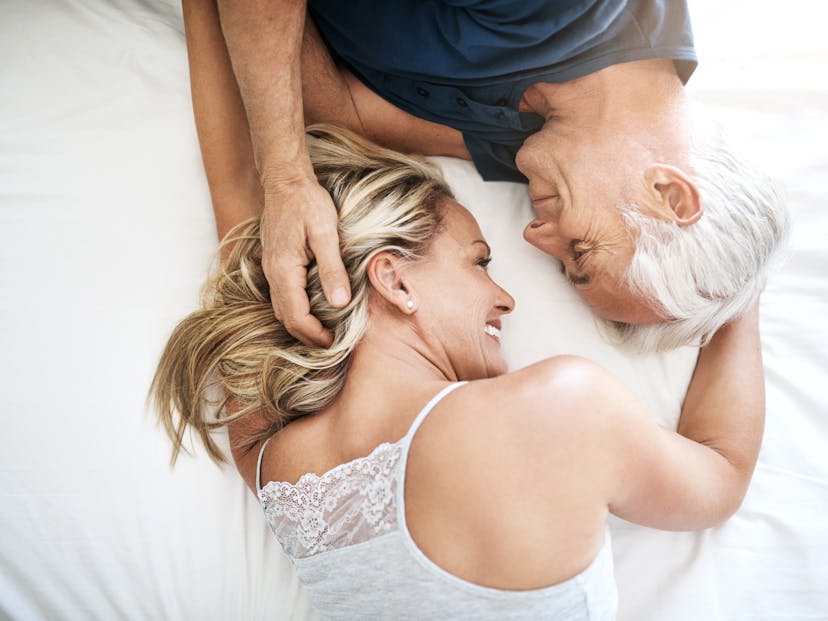 happy coupe laying on bed.