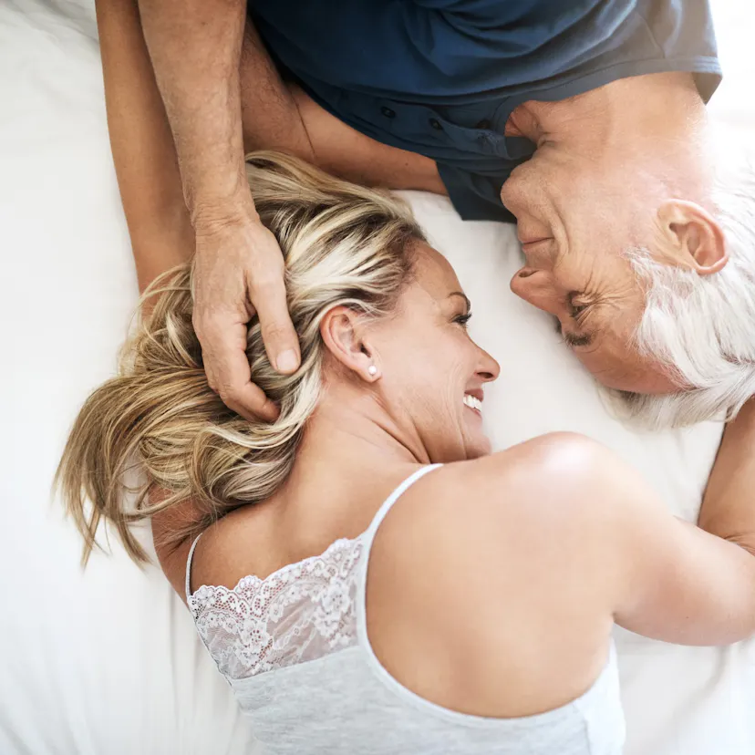 happy coupe laying on bed.