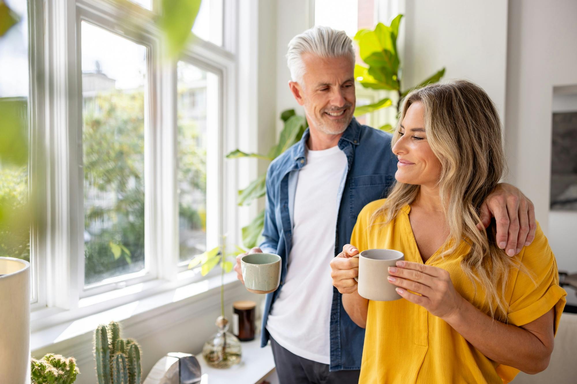happy couple at home drinking coffee