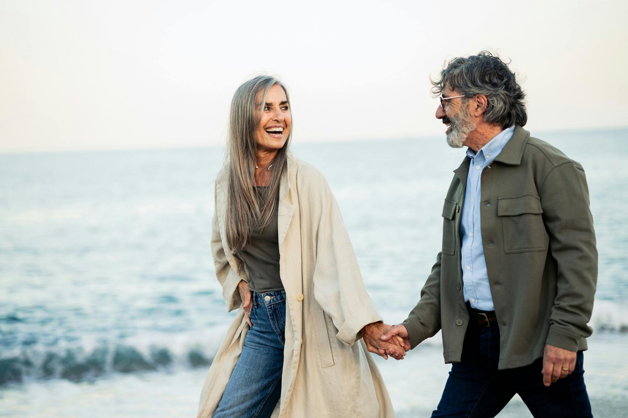 playful mature couple on the beach