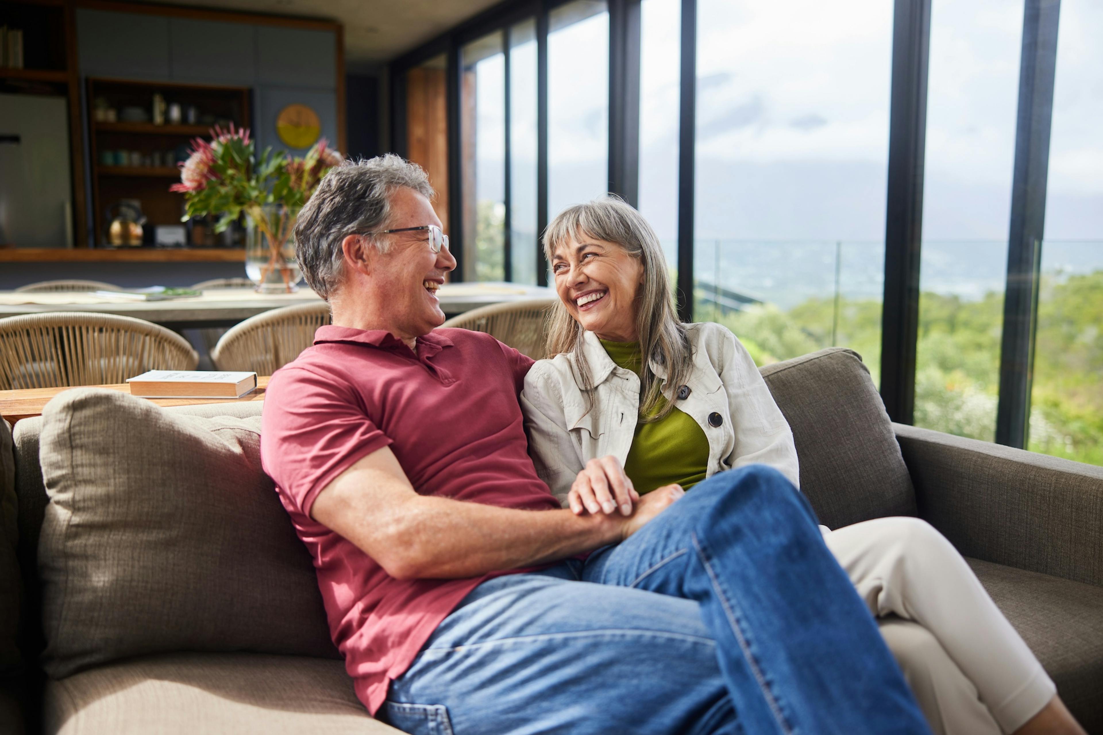 Mature couple sitting on their living room sofa