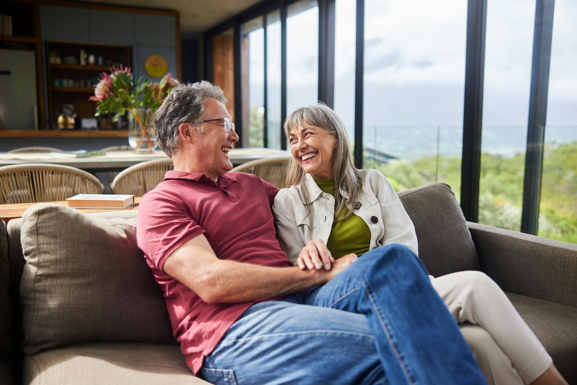 Mature couple sitting on their living room sofa
