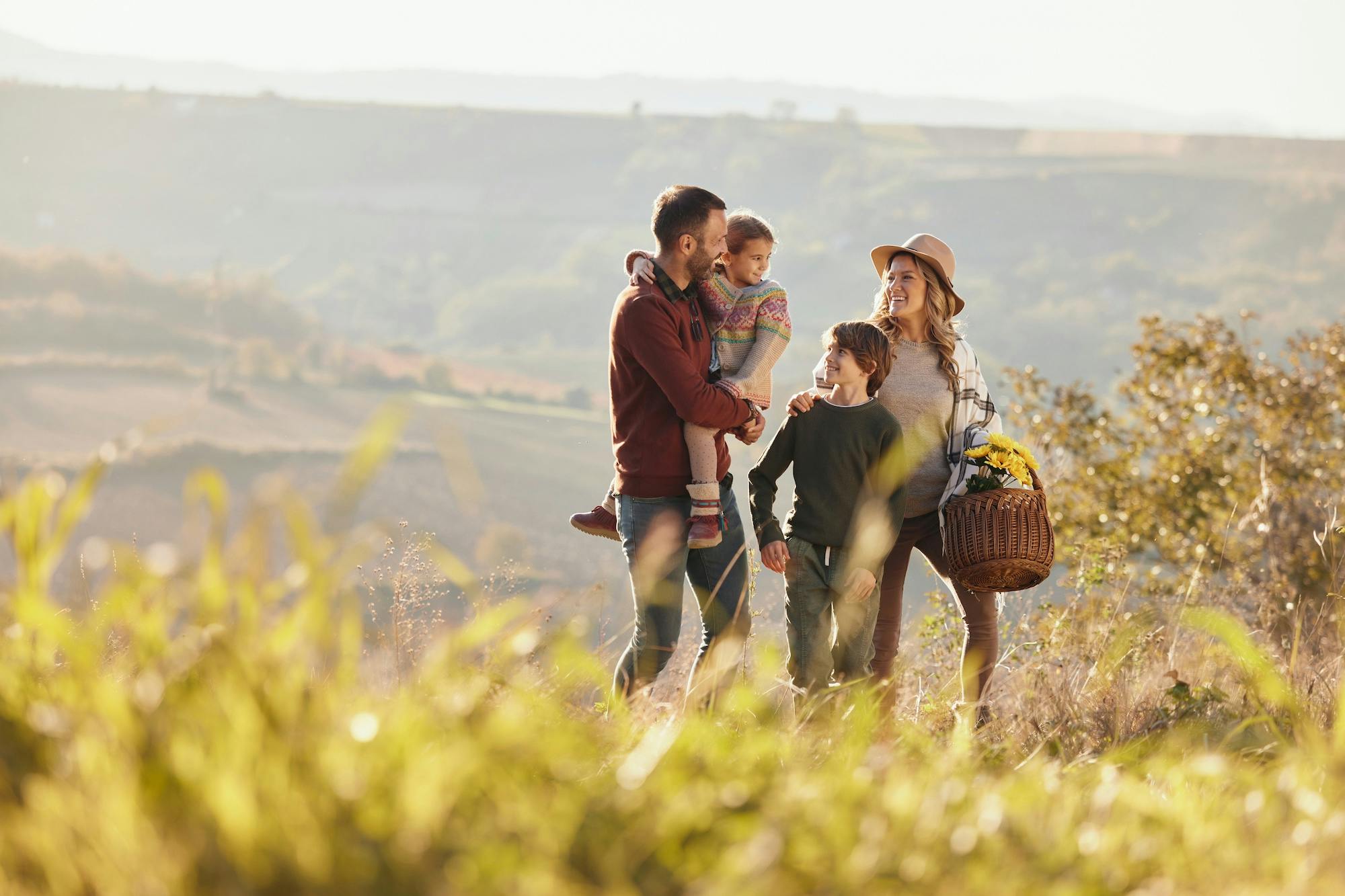Happy family talking while going on a picnic
