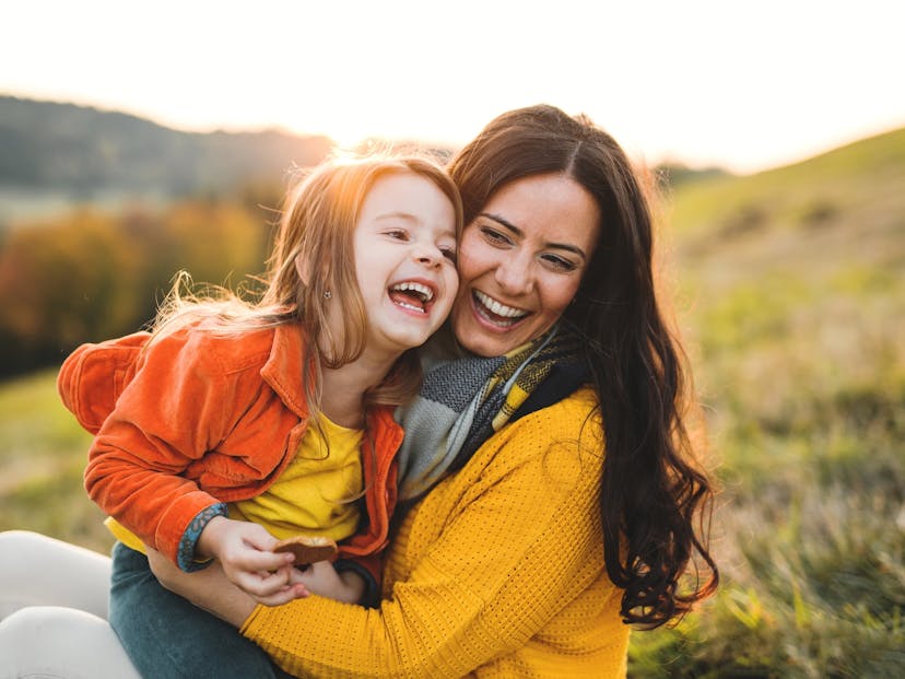 mother and daughter smiling at sunset
