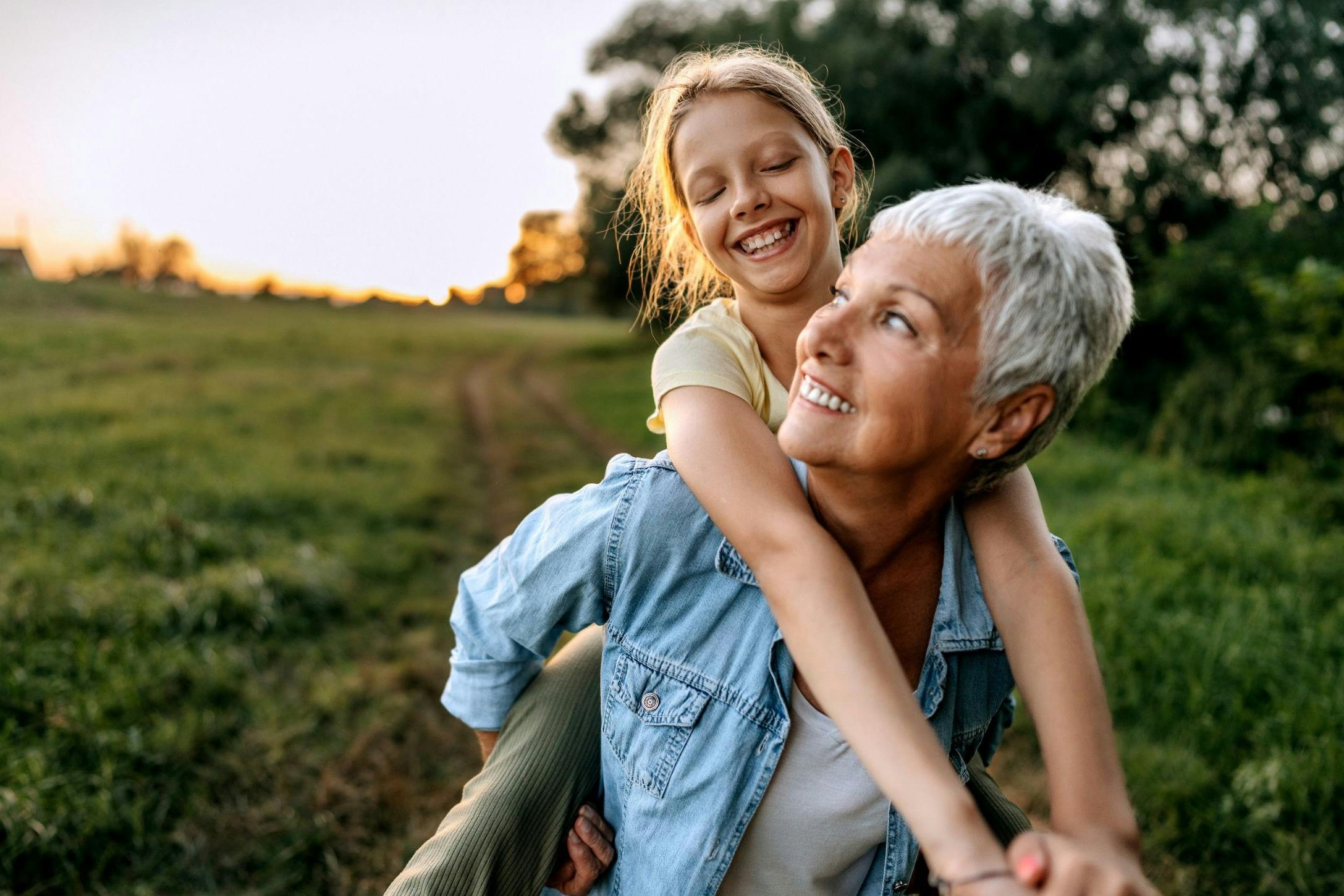 Grandmother carrying her granddaughter
