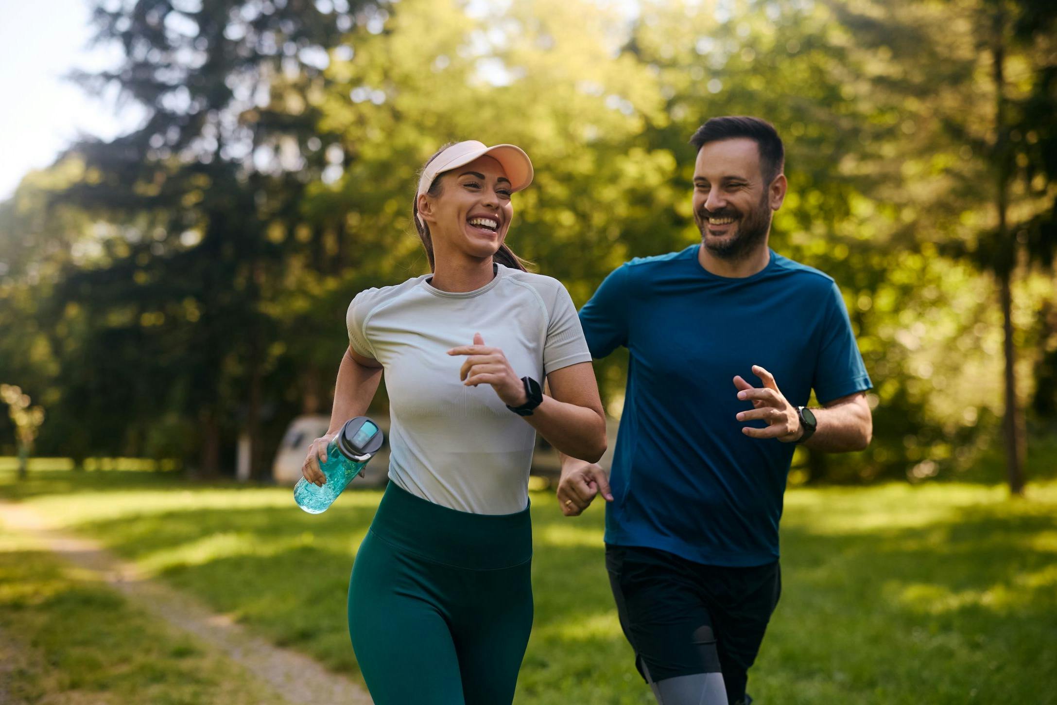 Cheerful athletic couple jogging