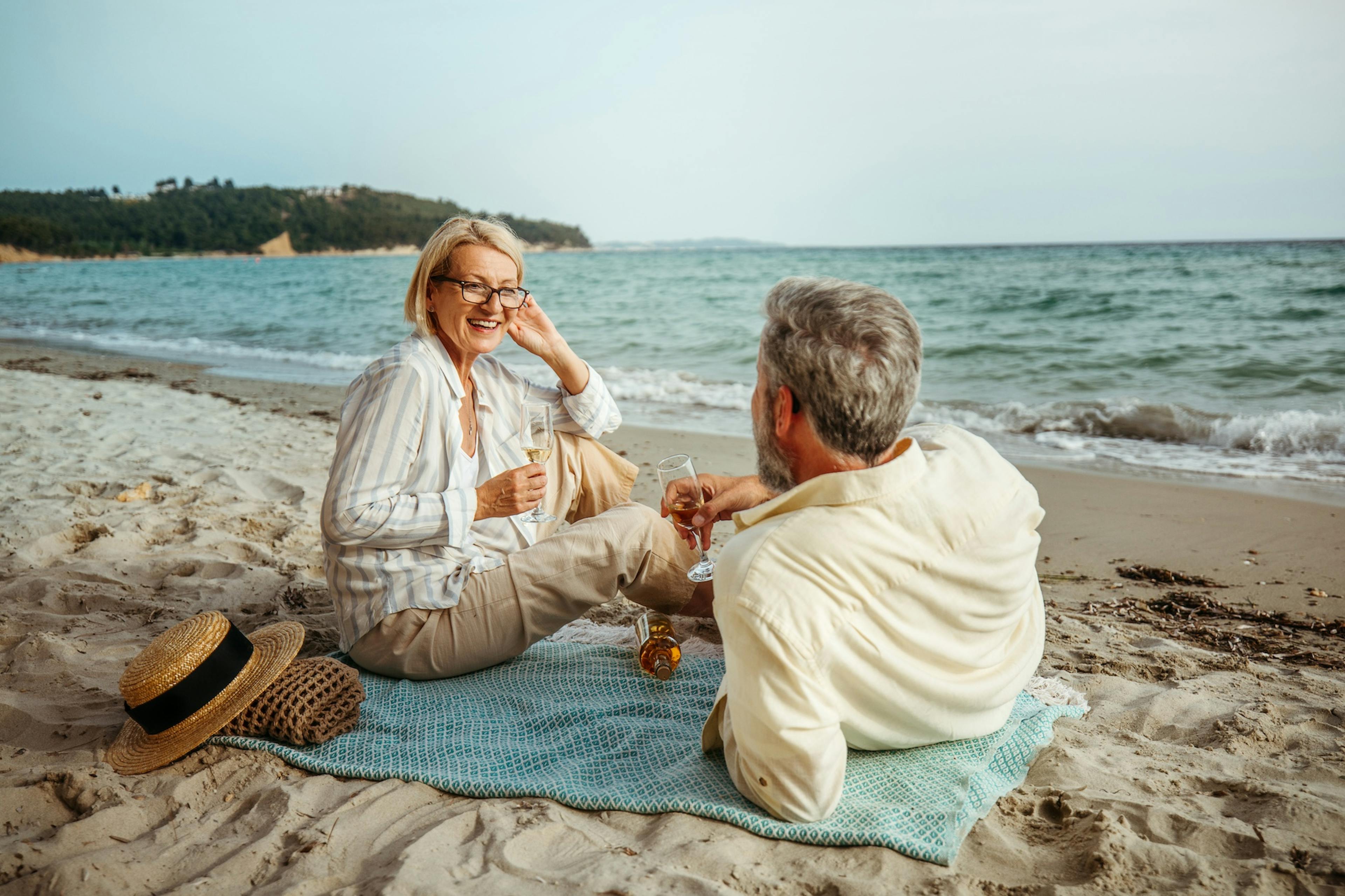 mature couple enjoying a picnic on a beach