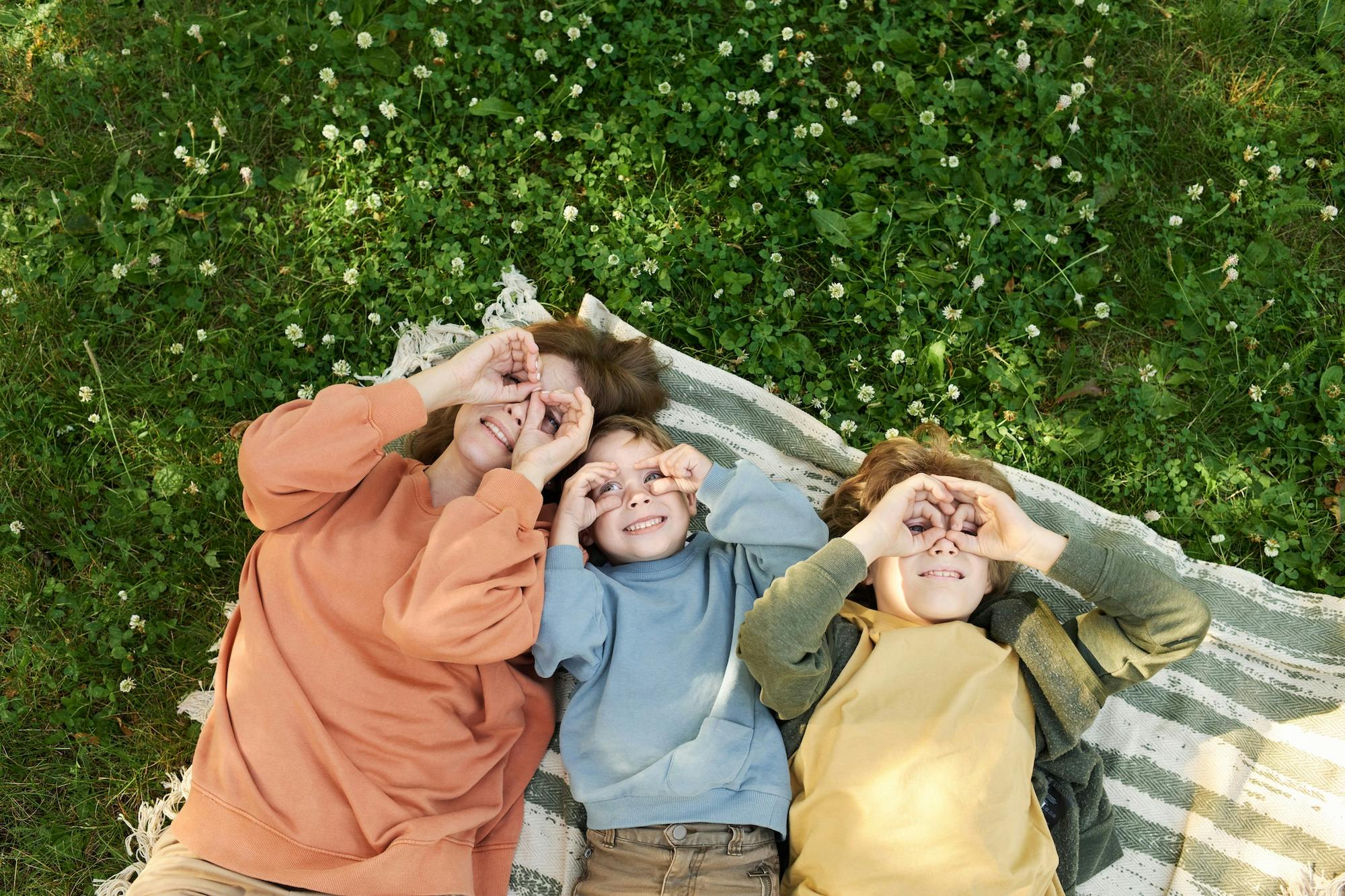 mother and children in the grass
