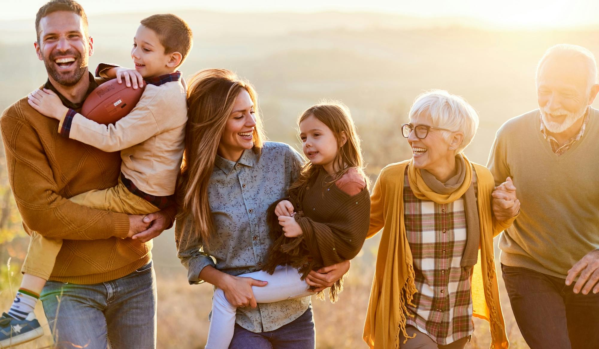 Happy multi-generation family taking a walk in nature.