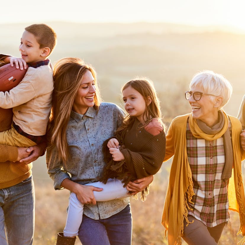 Happy multi-generation family taking a walk in nature.