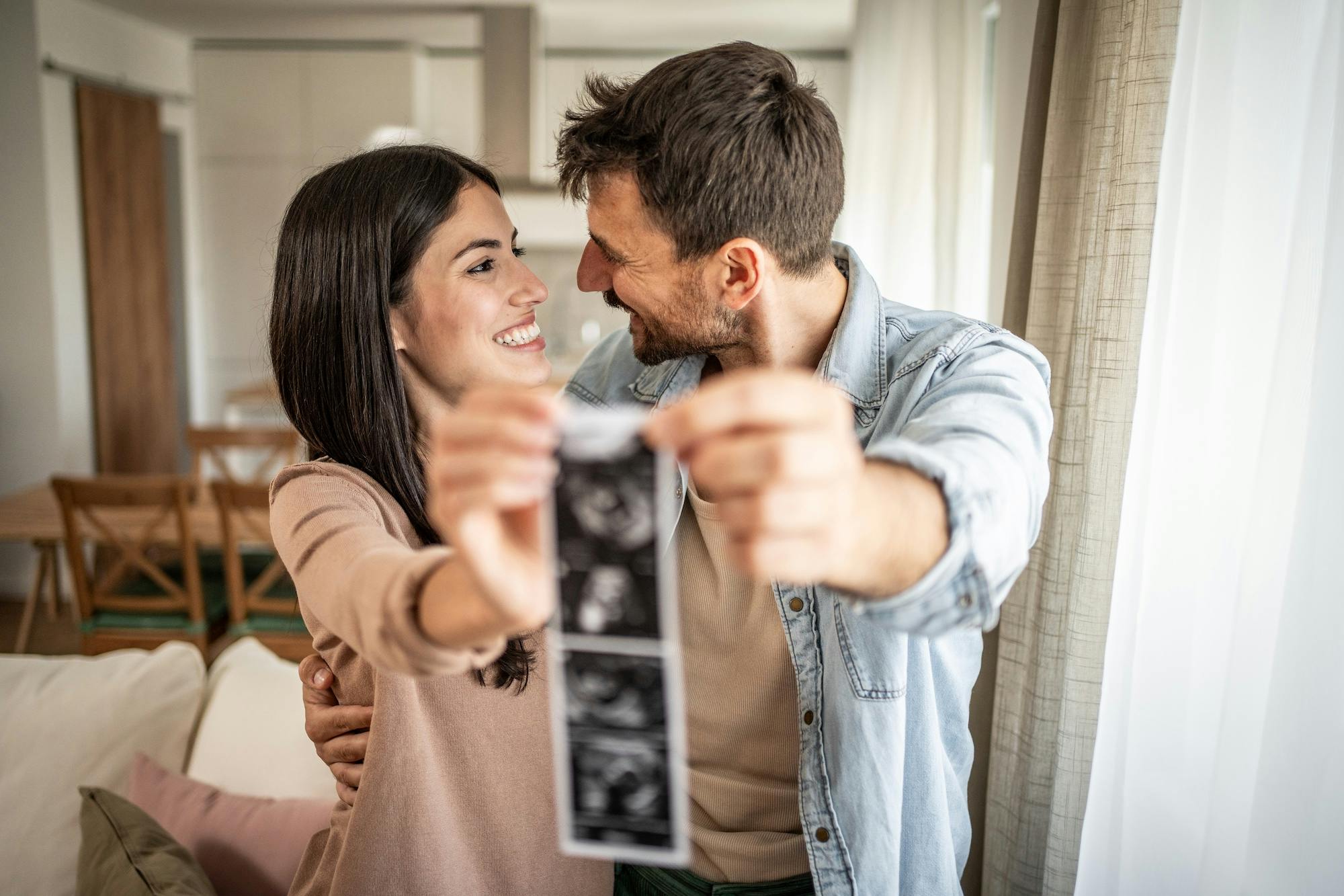 happy couple announcing pregancy