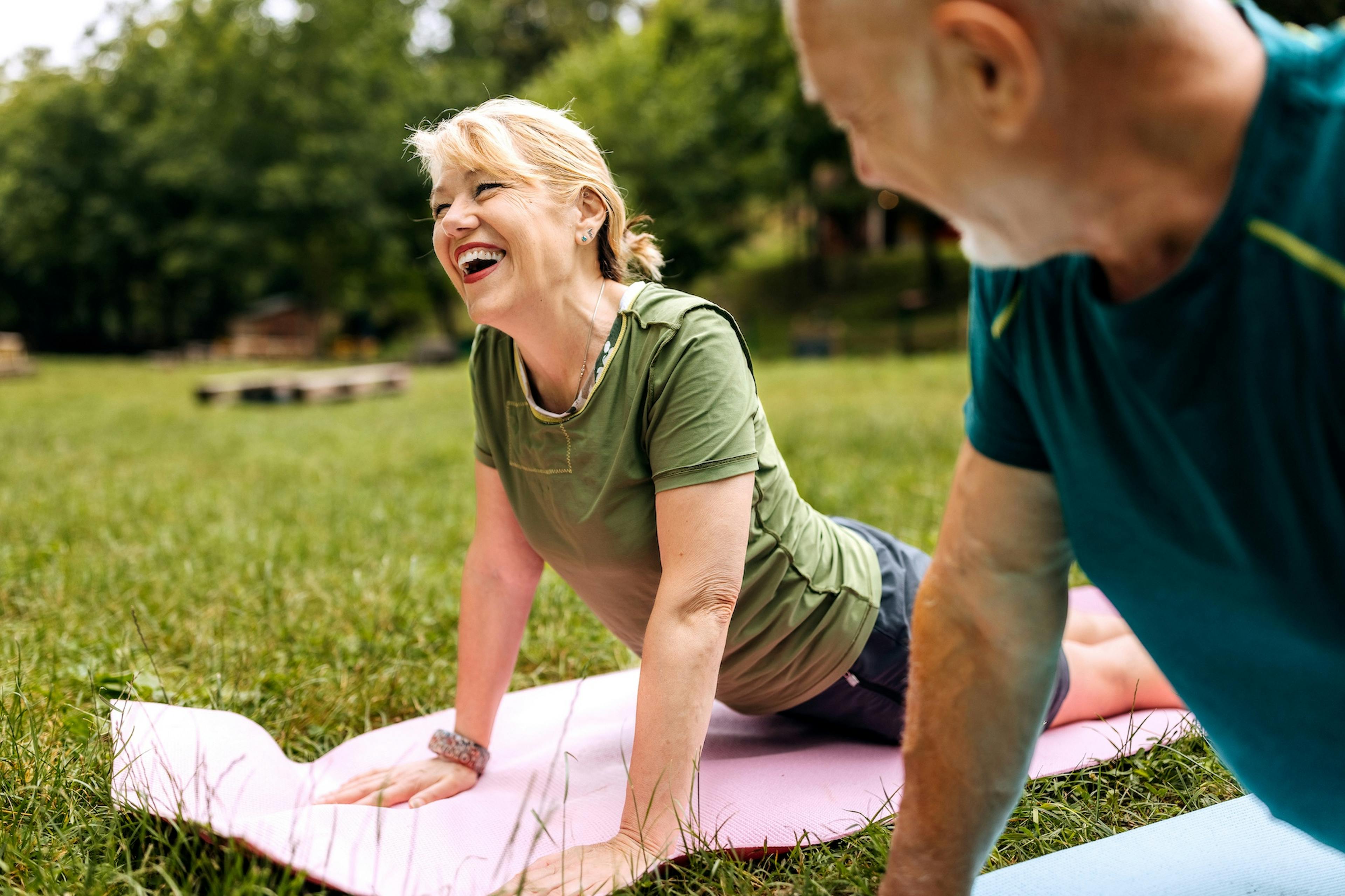 middle age woman doing yoga outside