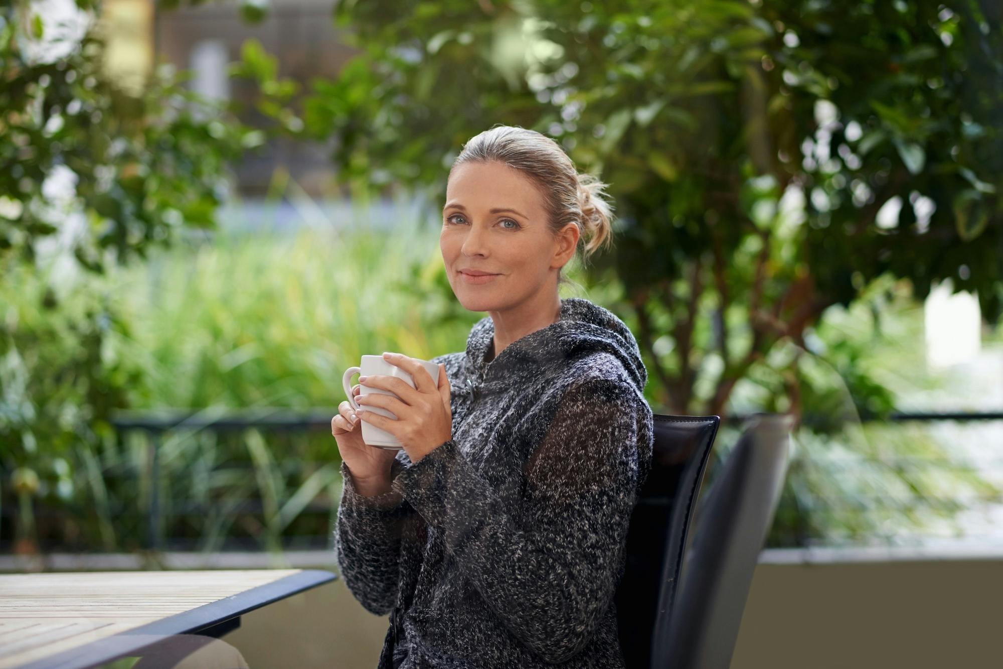 woman drinking coffee outside
