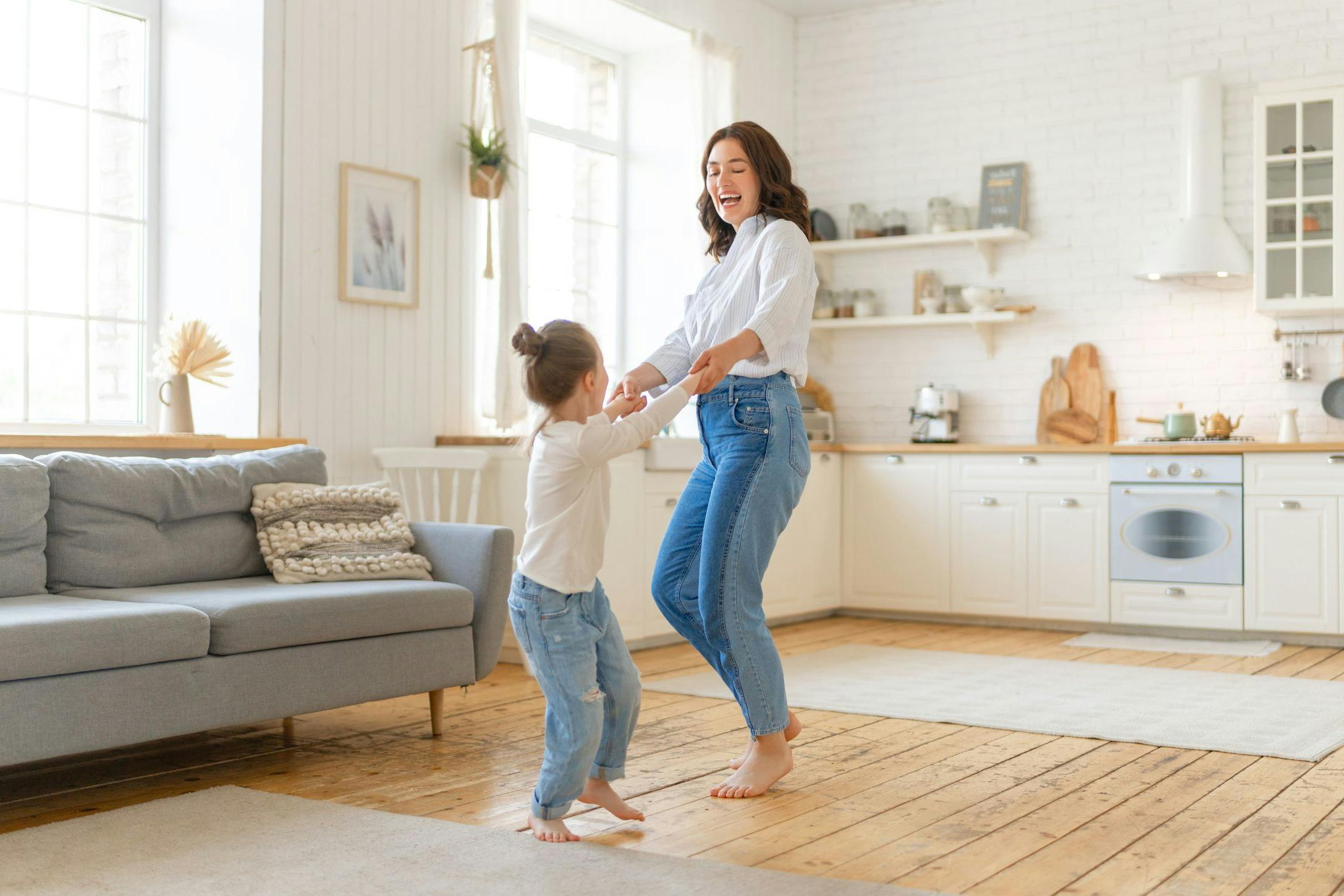 happy mom dancing with daughter
