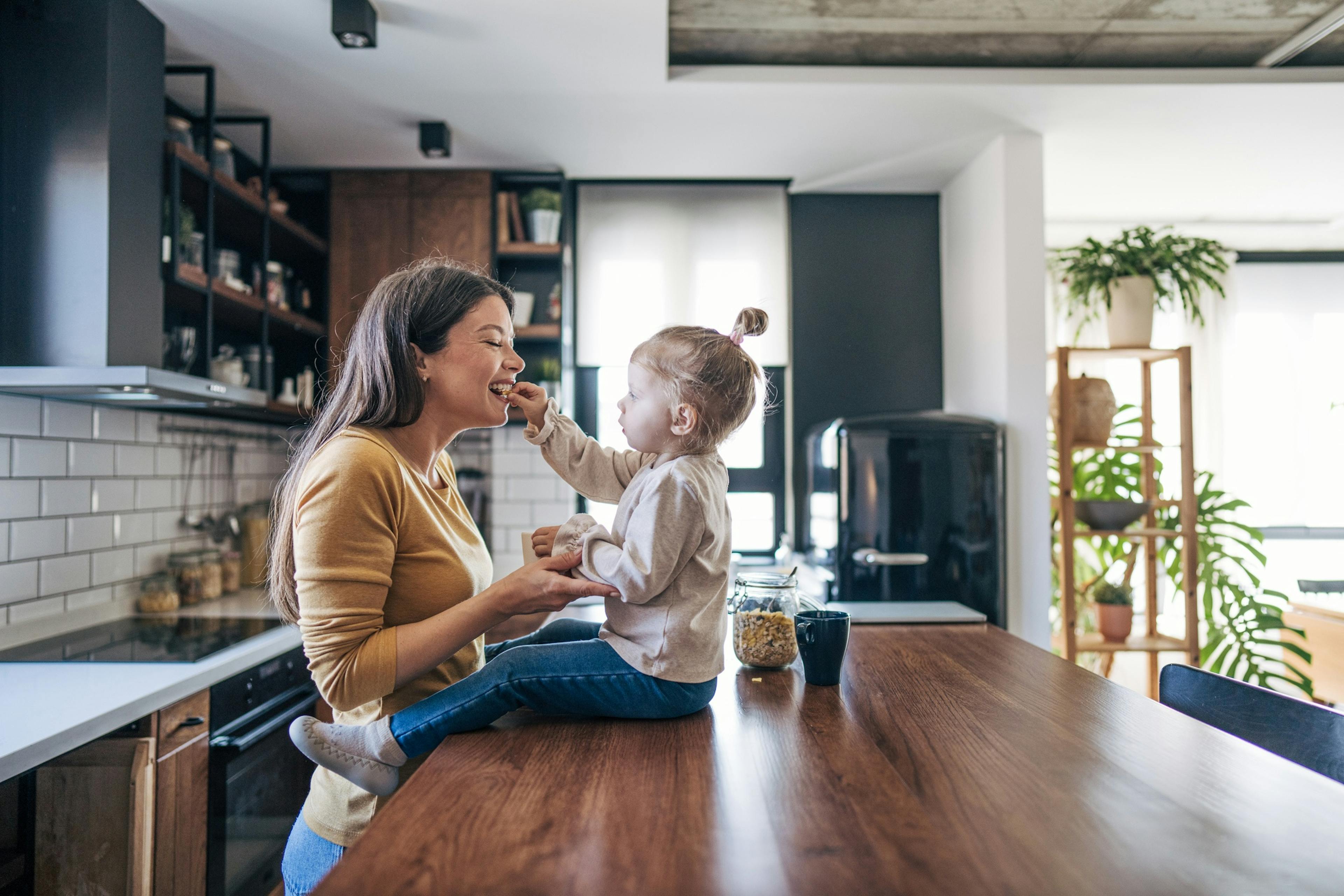 happy mom and daughter in kitchen