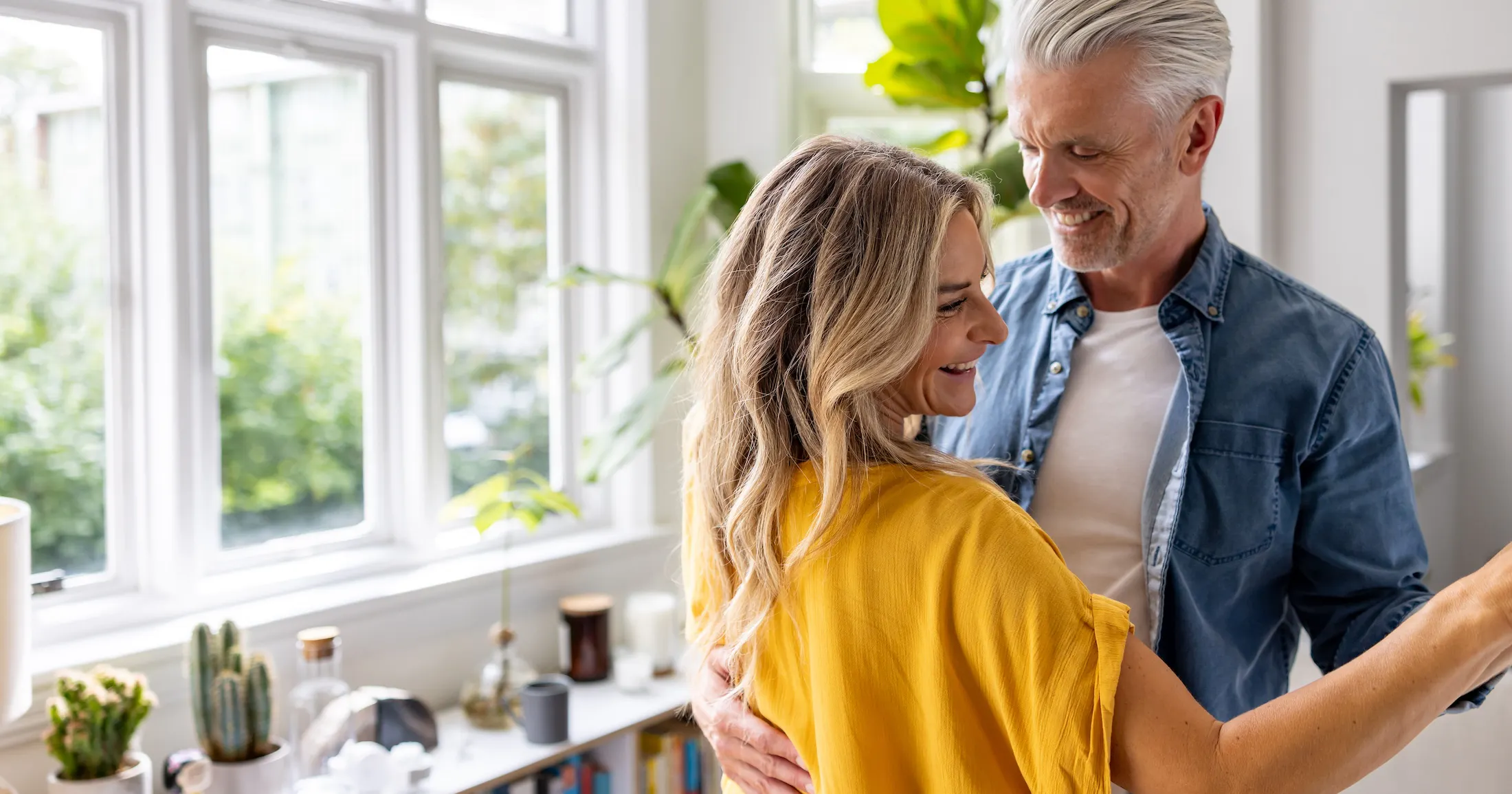 Loving couple dancing together at home