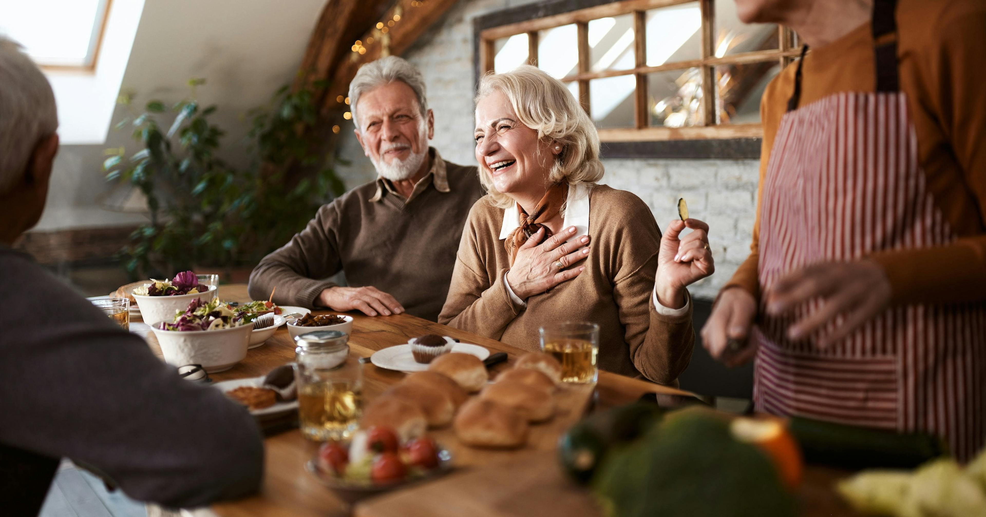 Cheerful senior couples talking at dinner.jpg