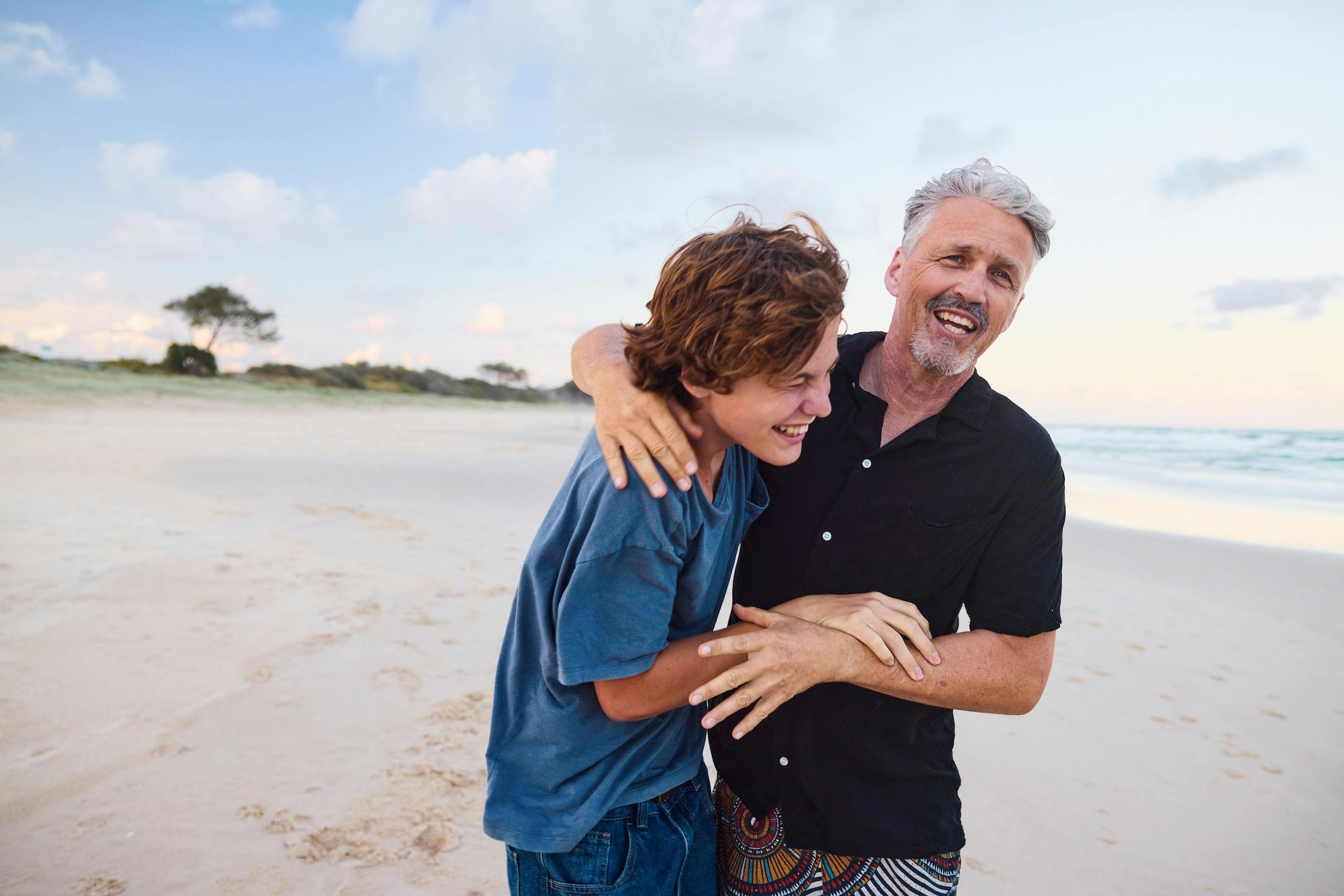 Father and son laughing and hugging