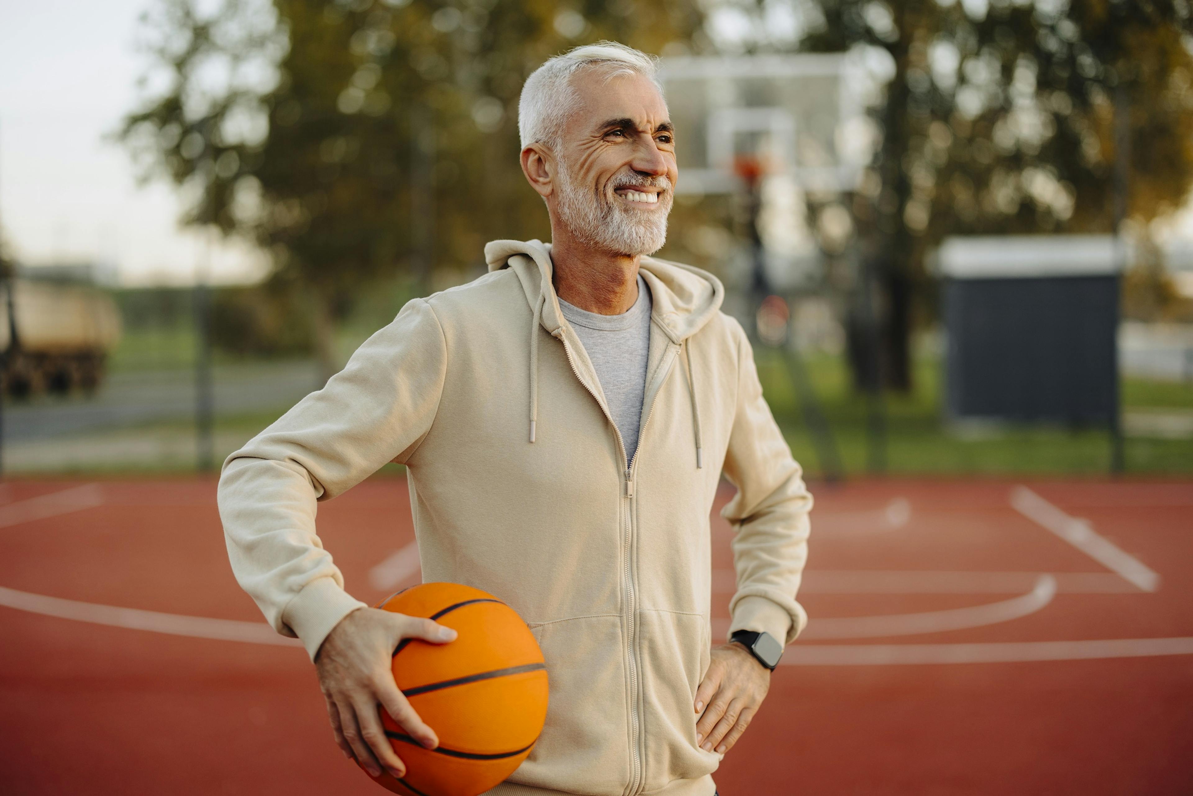middle age man playing basketball