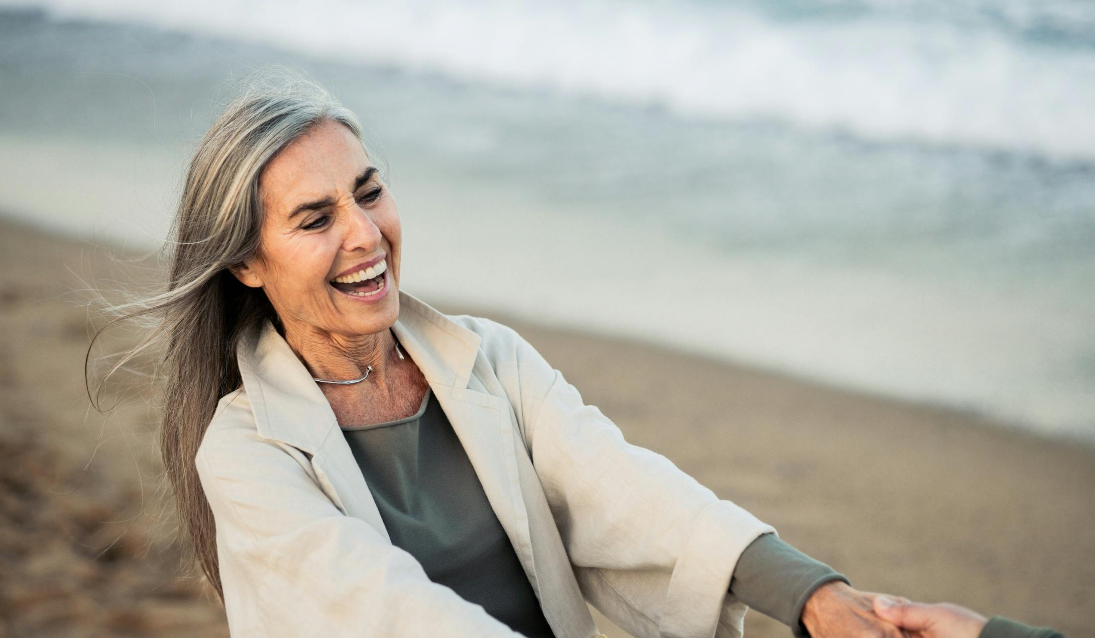 Happy mature woman enjoying a romantic beach vacation