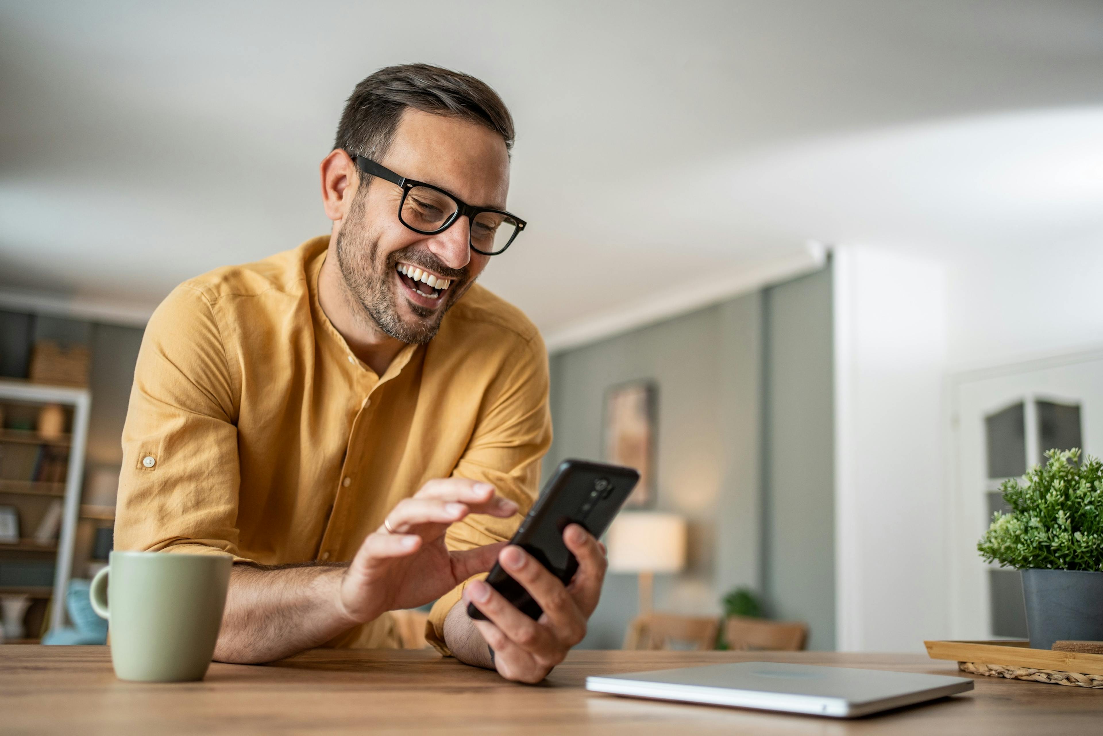 smiling man looking at phone