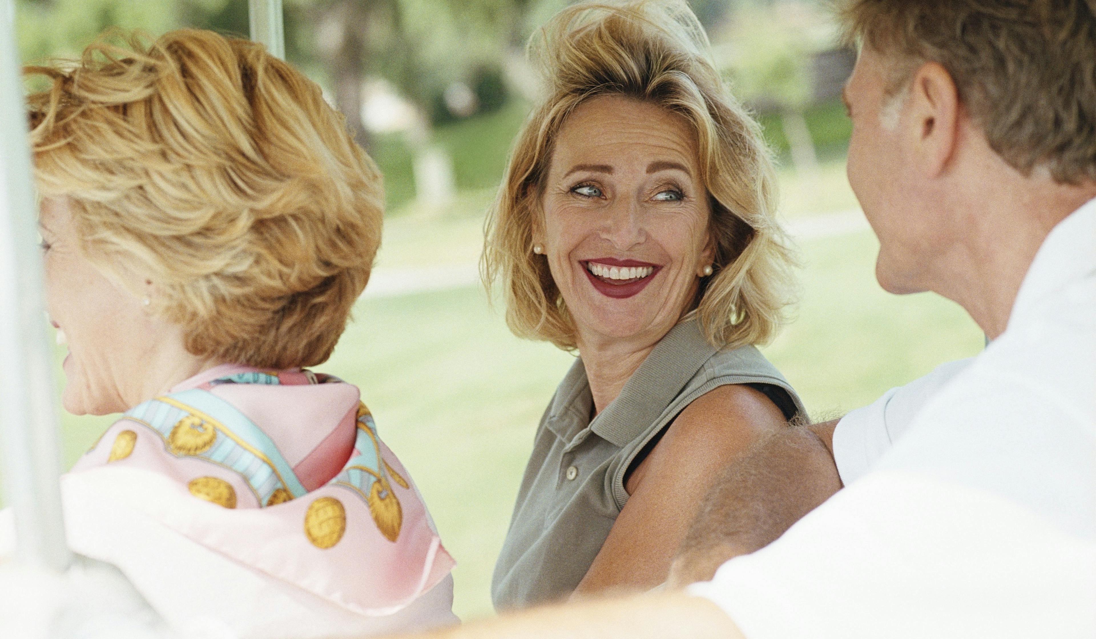 Woman with others in golf cart