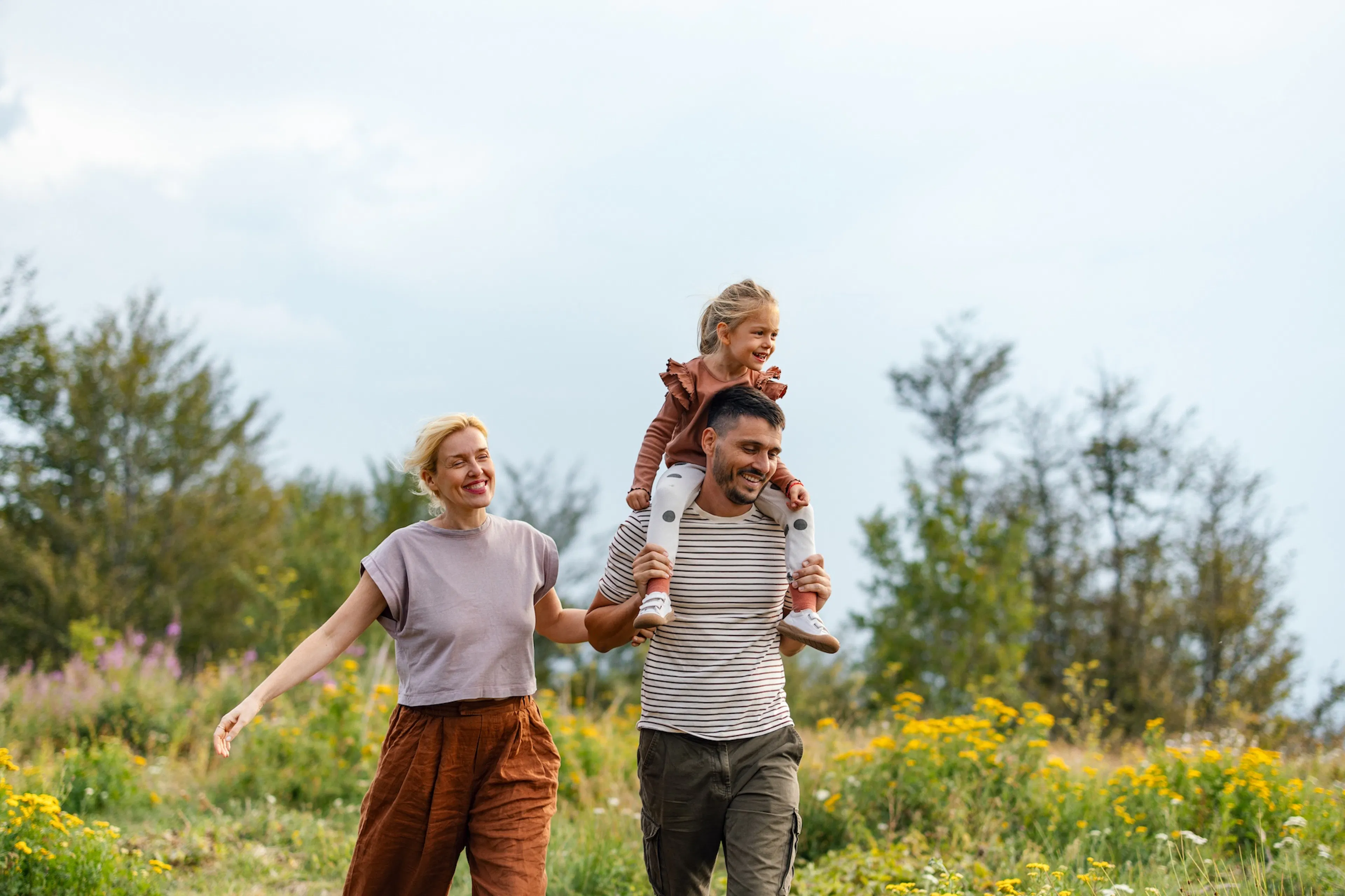 family walking in the sunshine