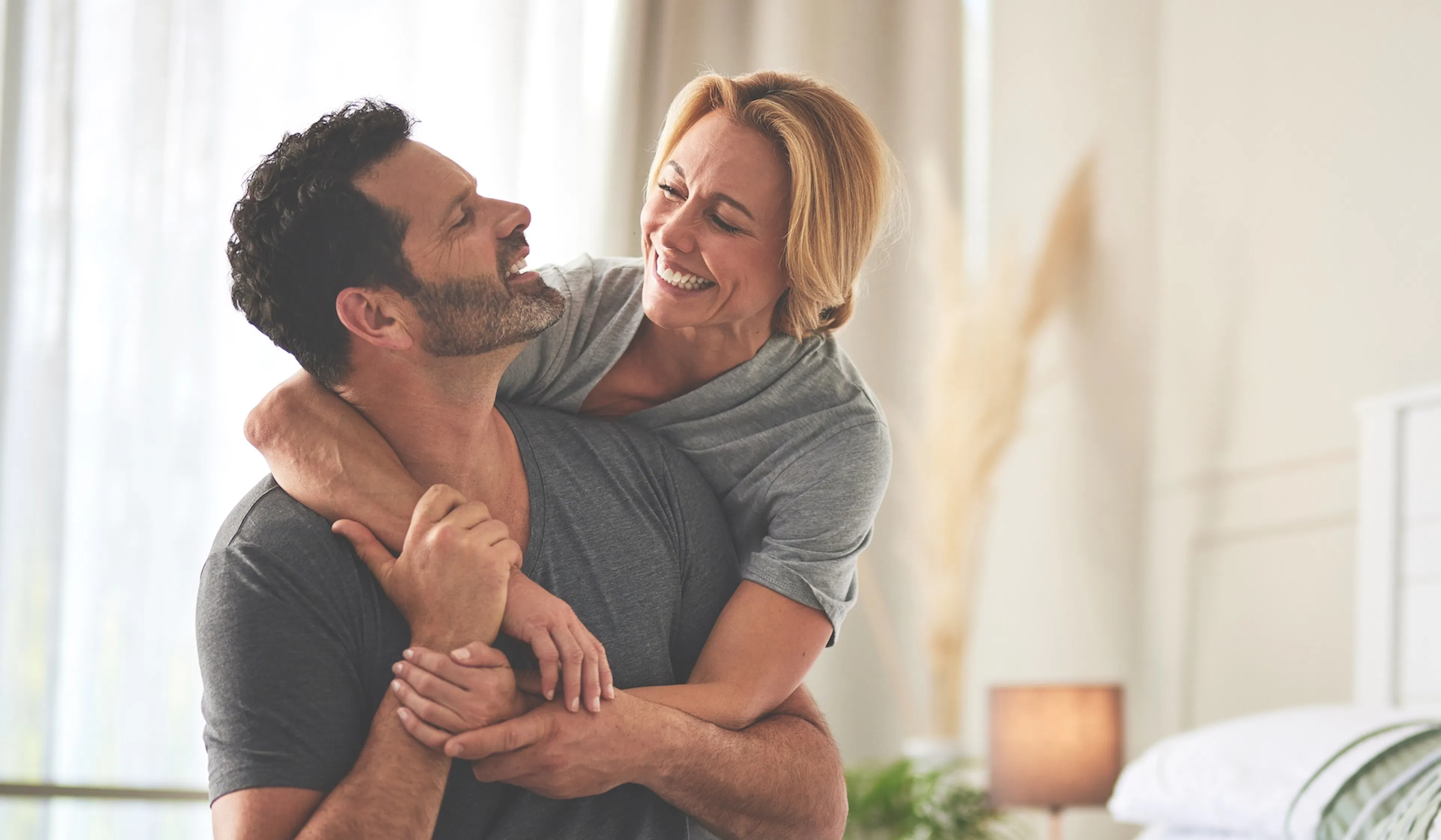 happy couple laughing in the morning