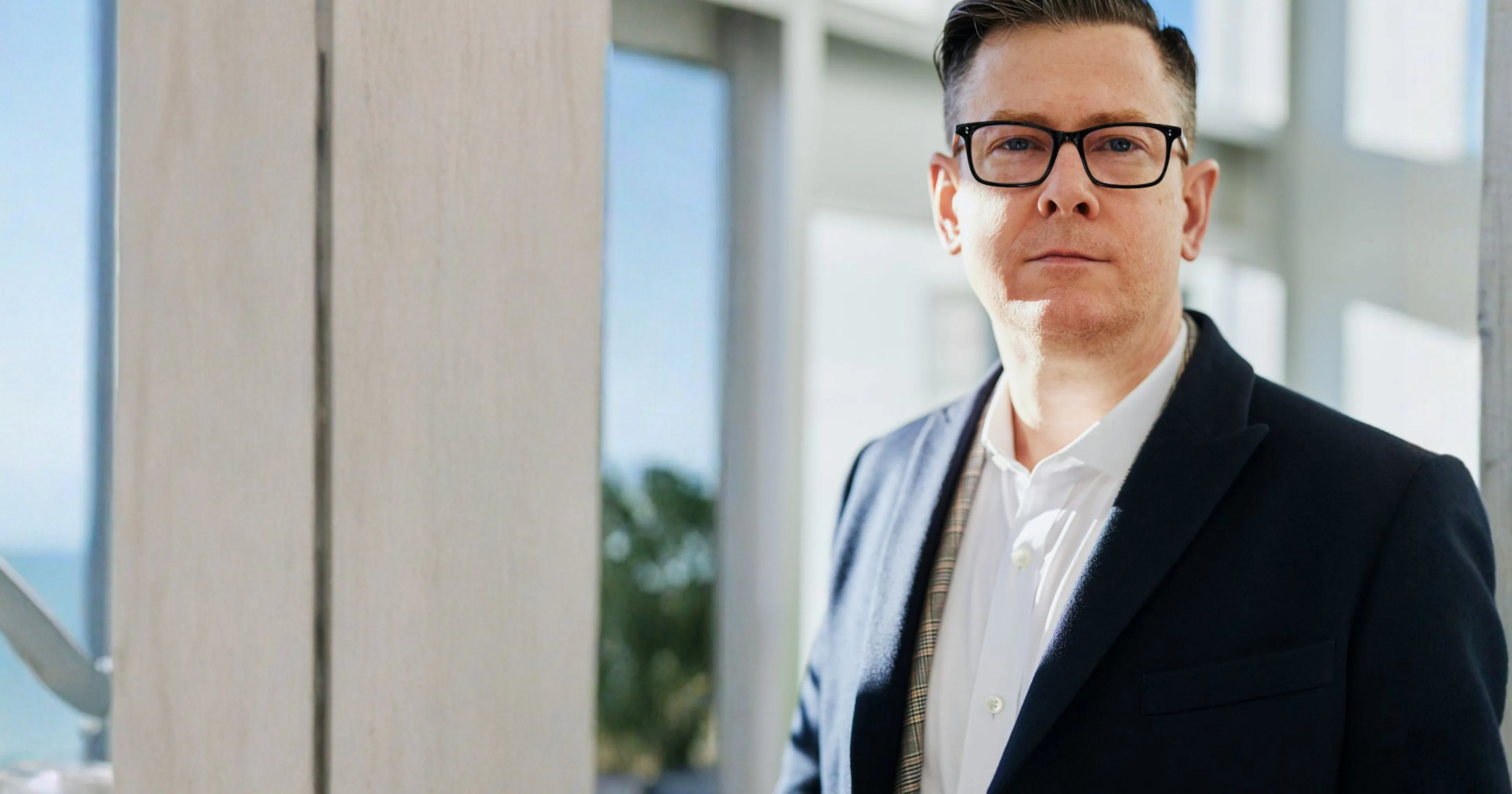 man standing near windows