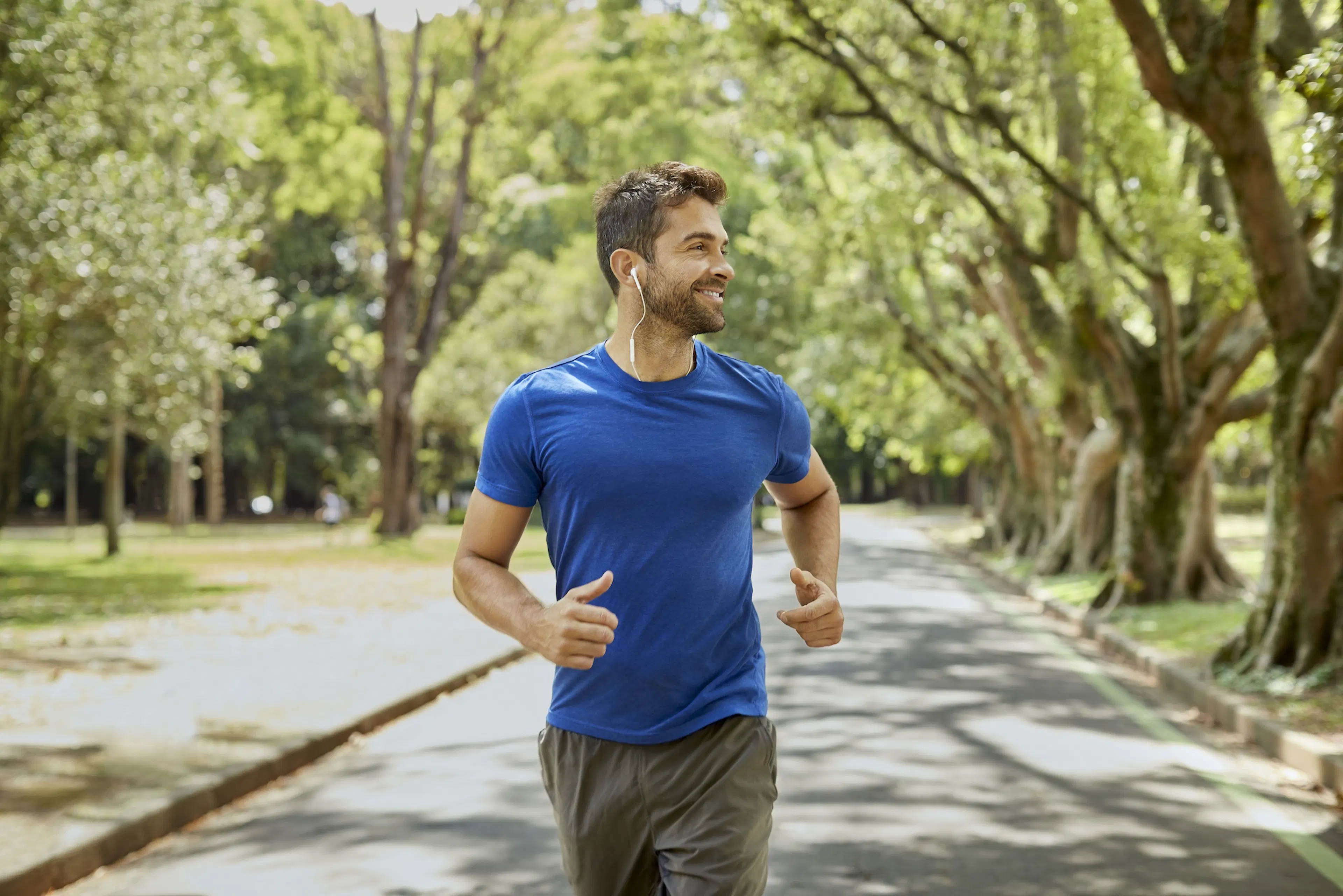 man running beneath the trees