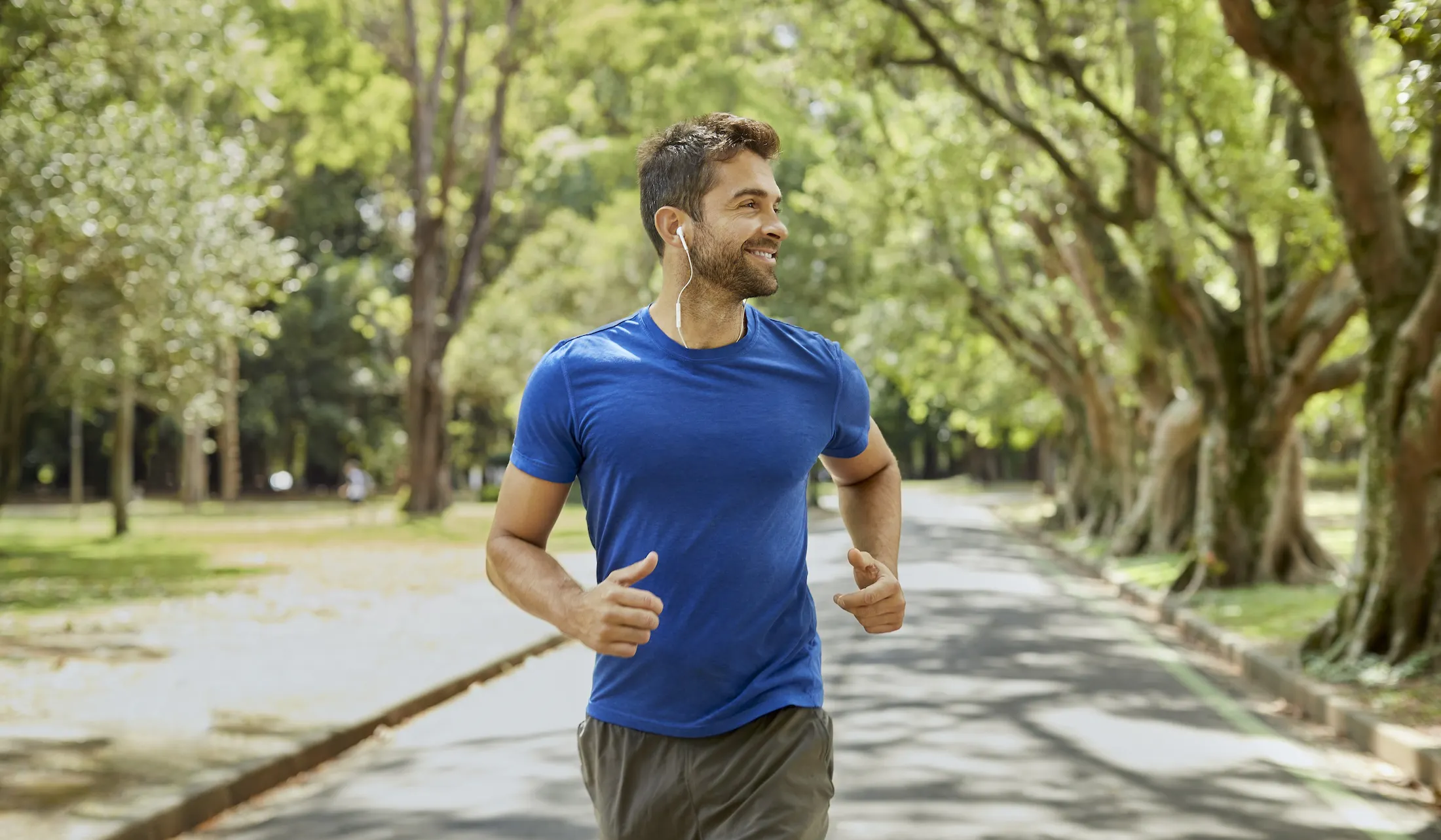 man running beneath the trees