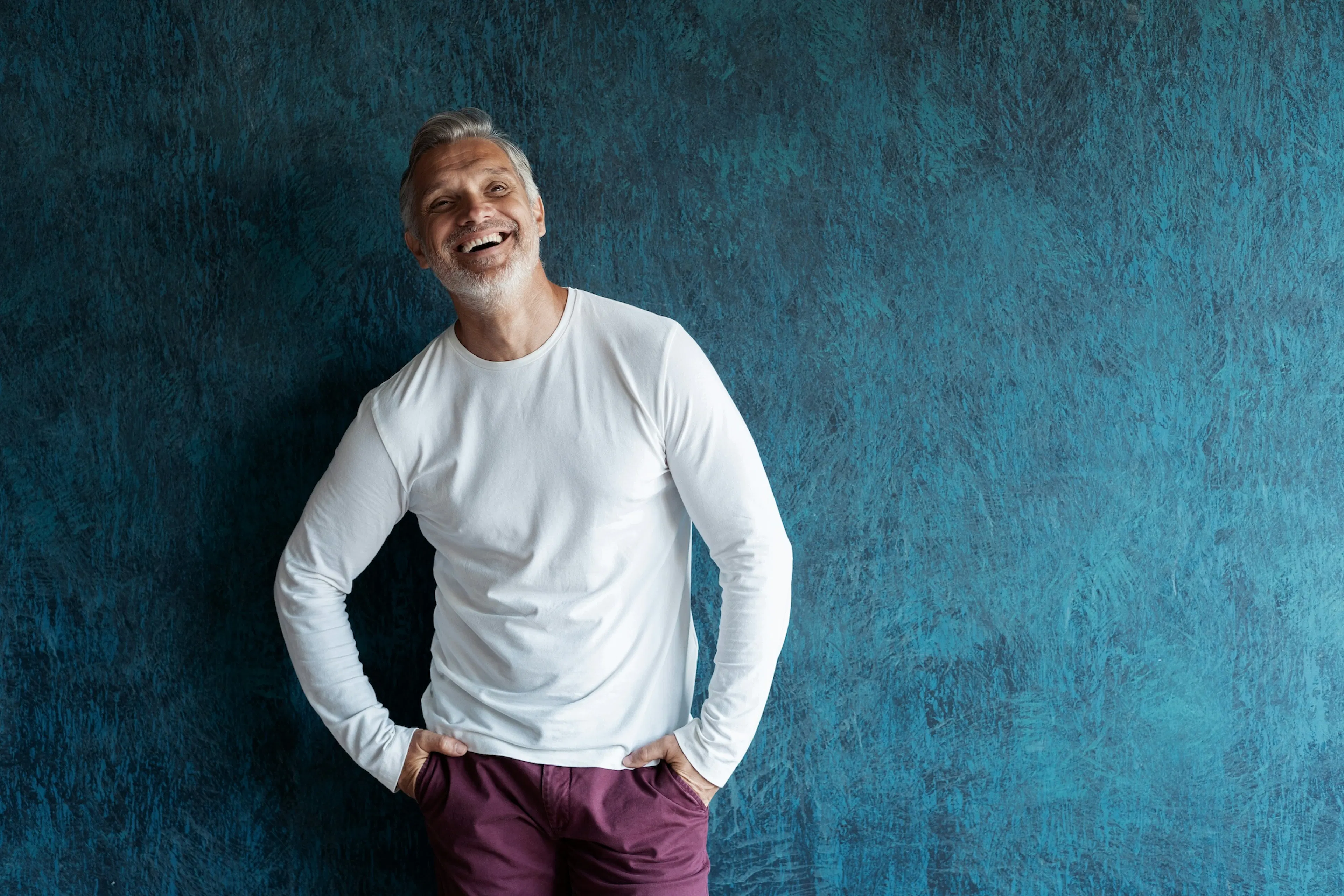 middle age man laughing in a white shirt
