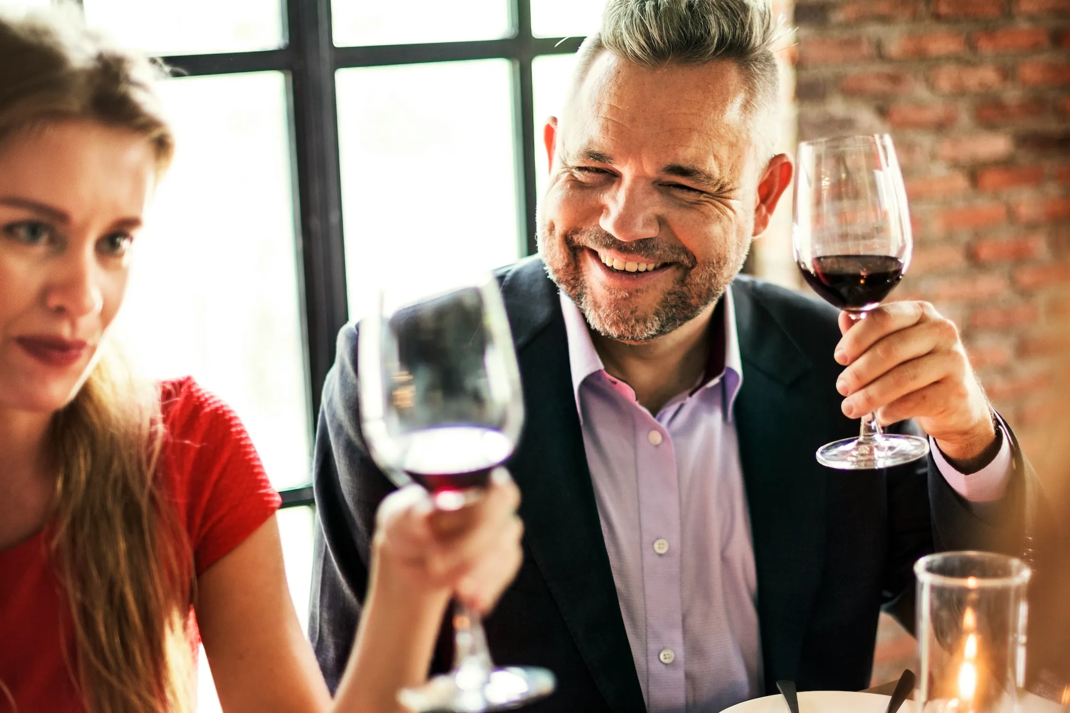 man enjoying wine at dinner