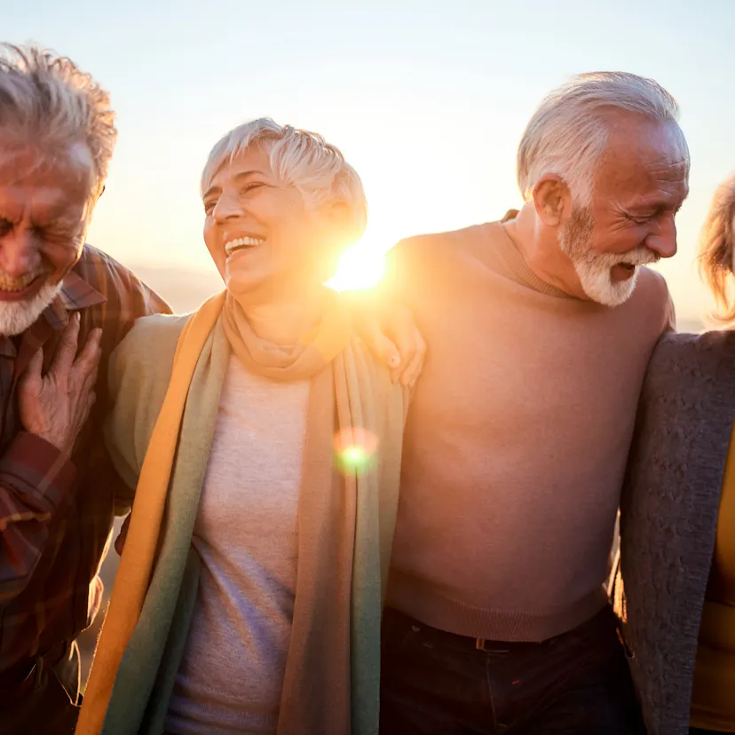 middle age friends walking at sunset
