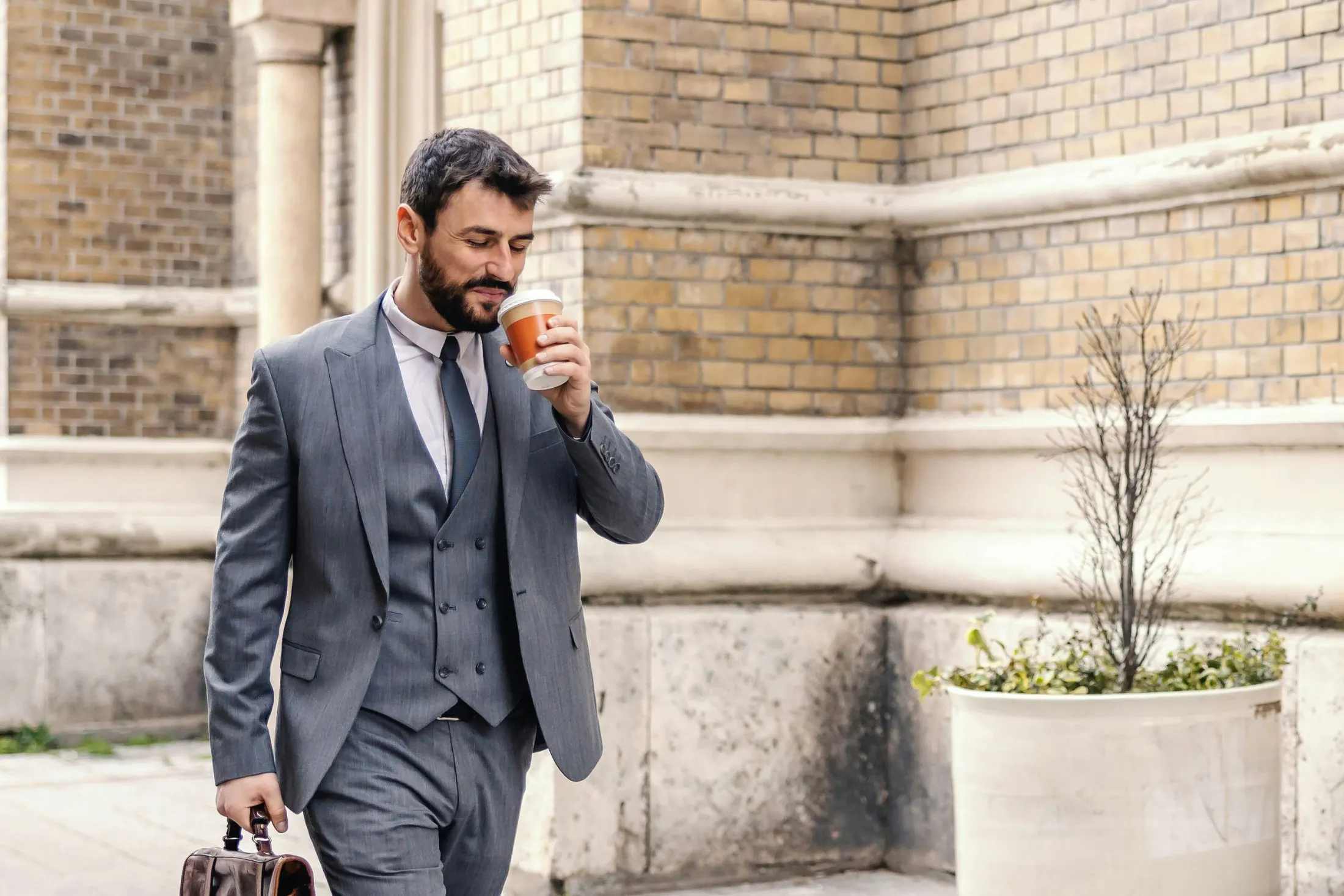 business man walking with coffee