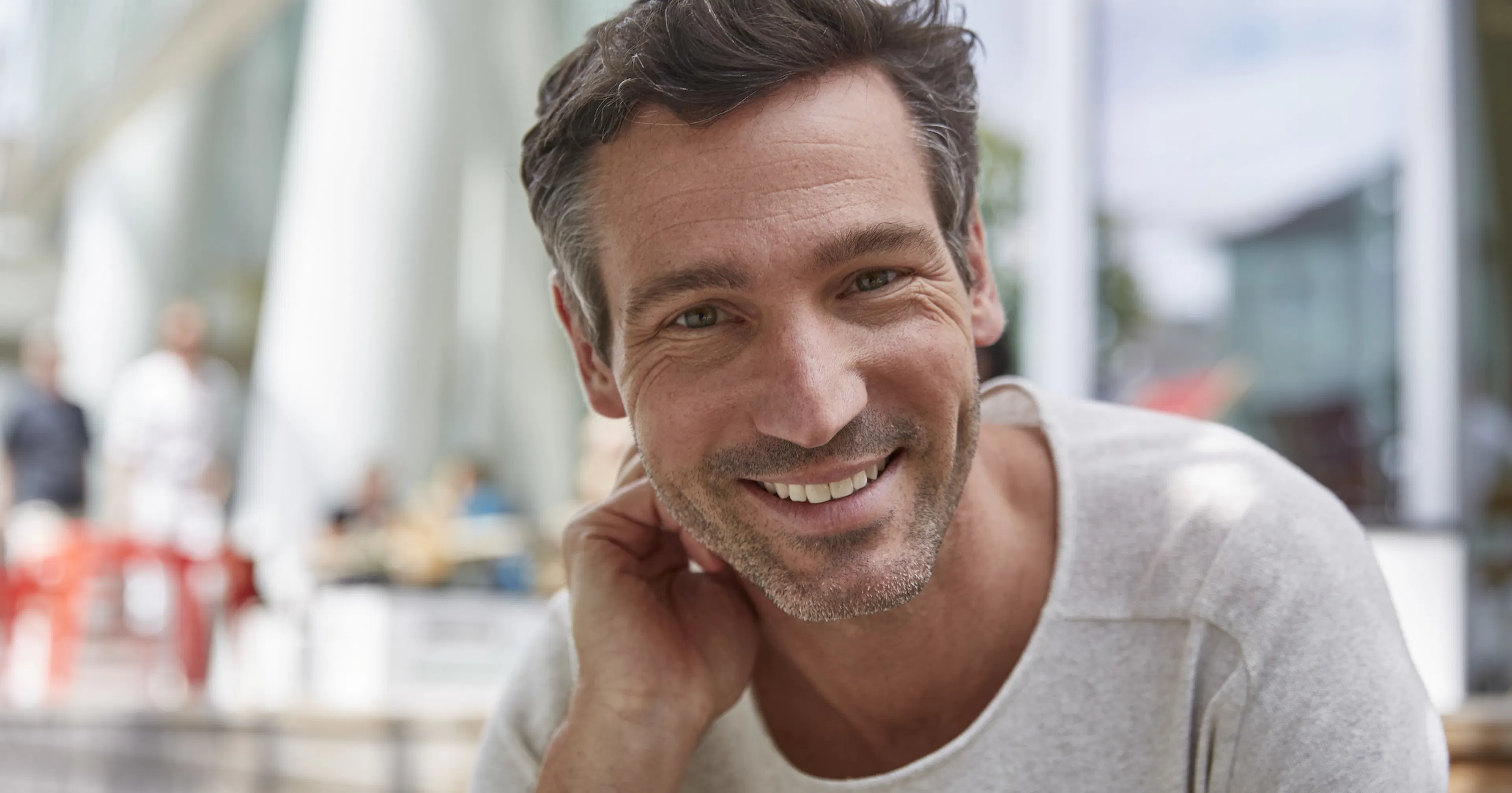 Portrait of smiling man at an outdoor cafe