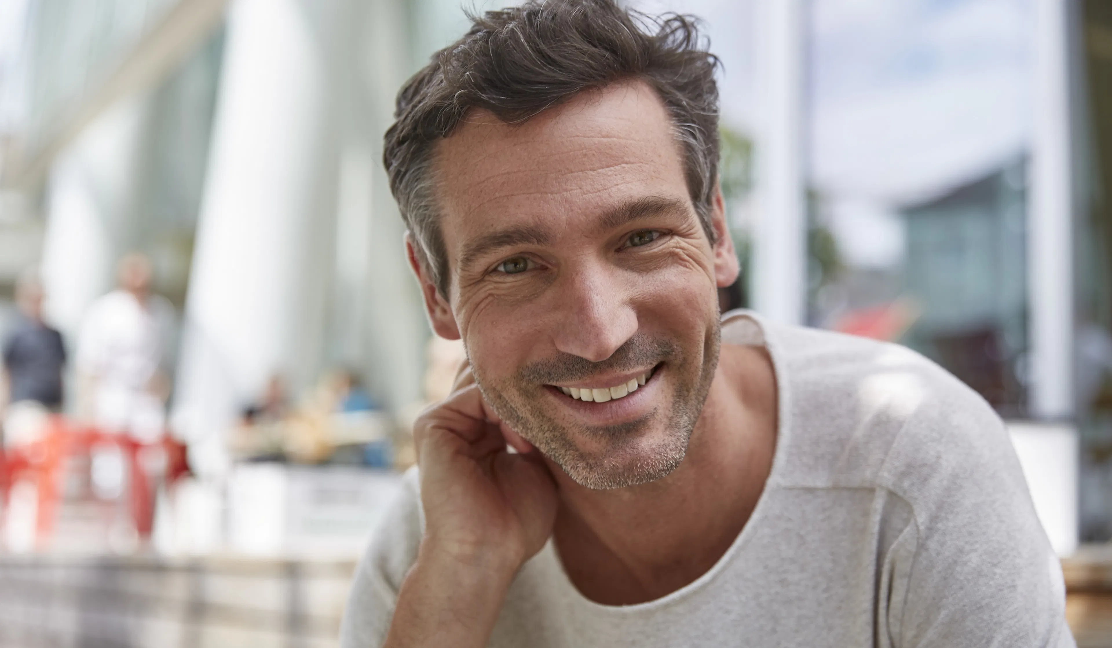 Portrait of smiling man at an outdoor cafe