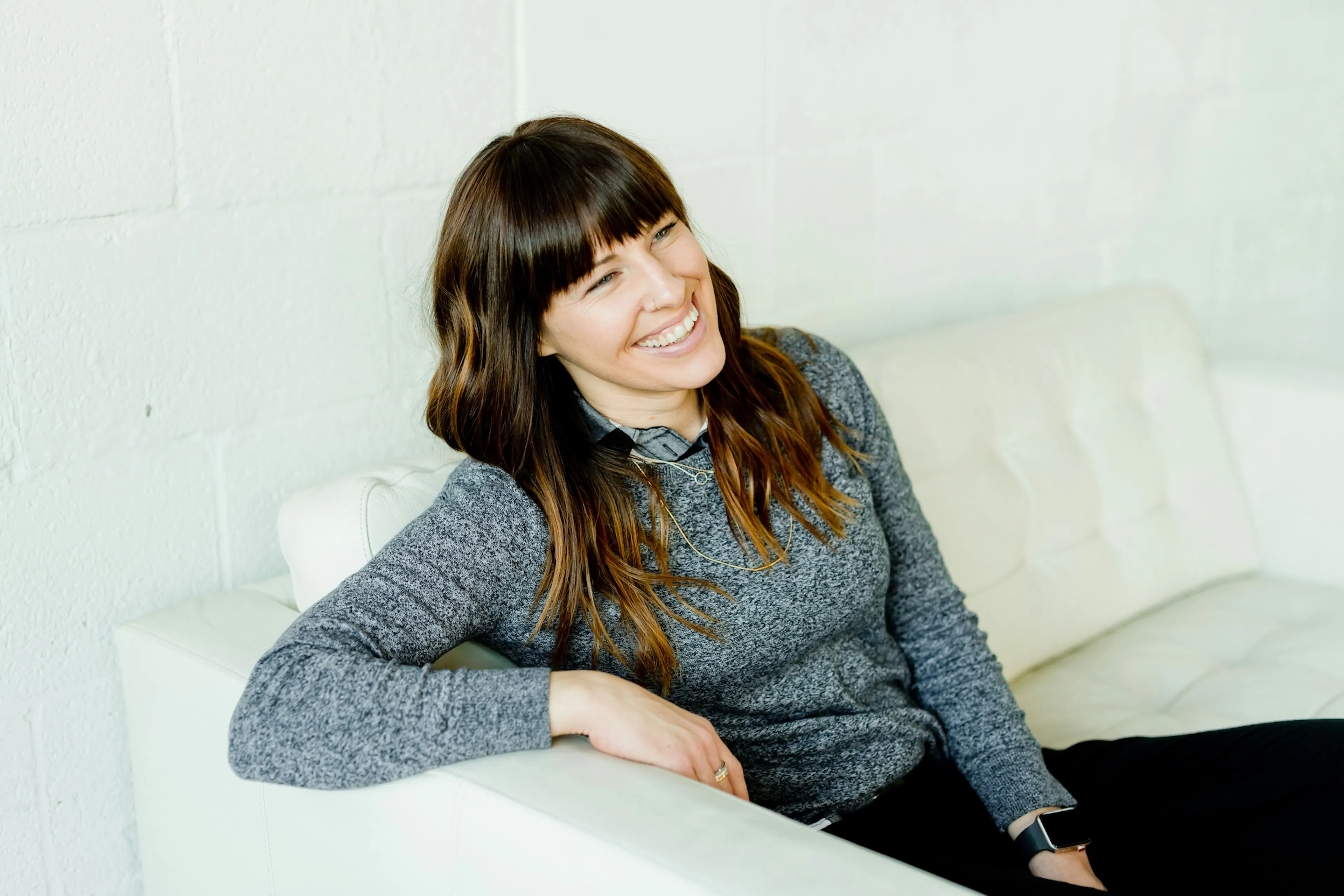 woman laughing on the couch