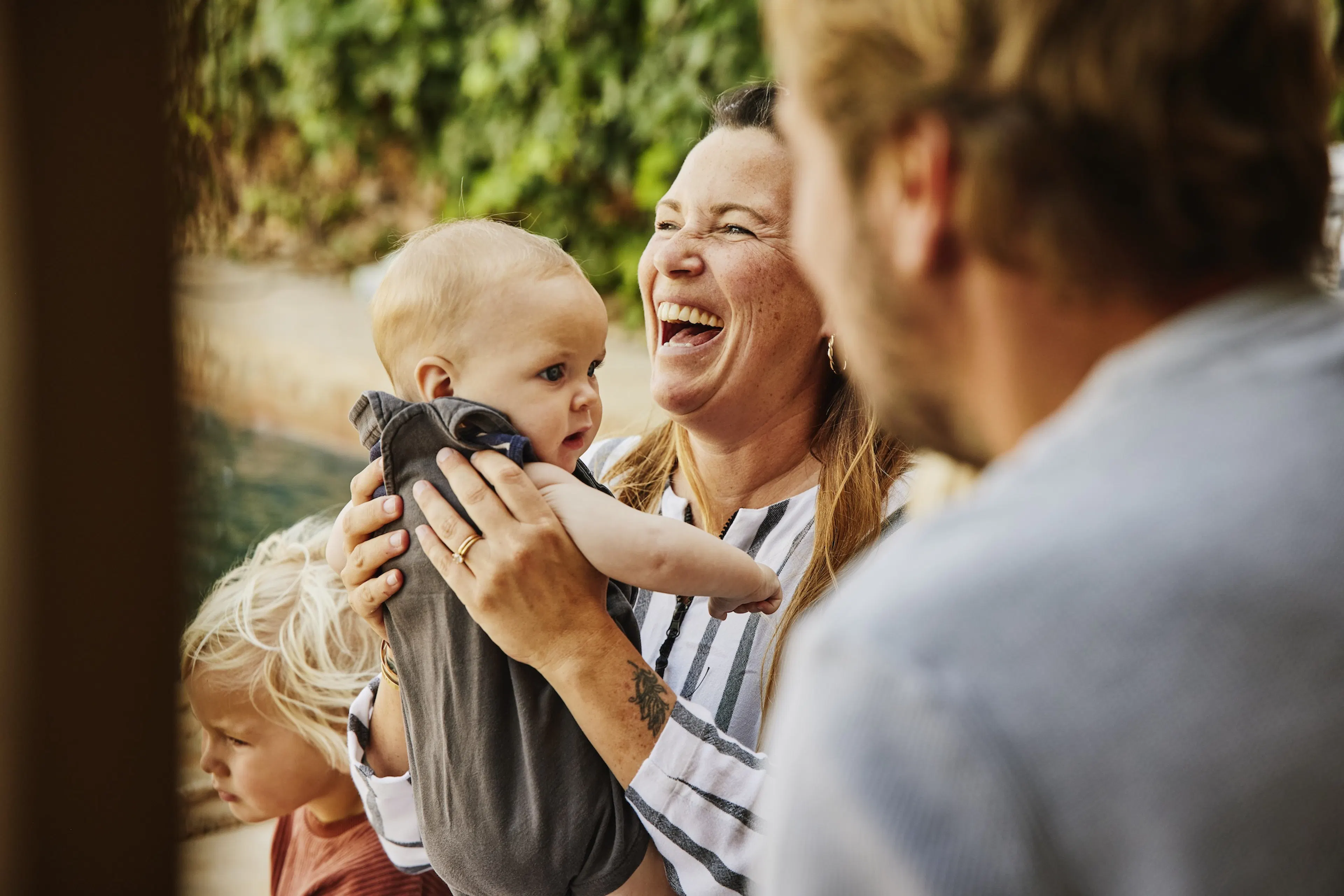 laughing mother holding son